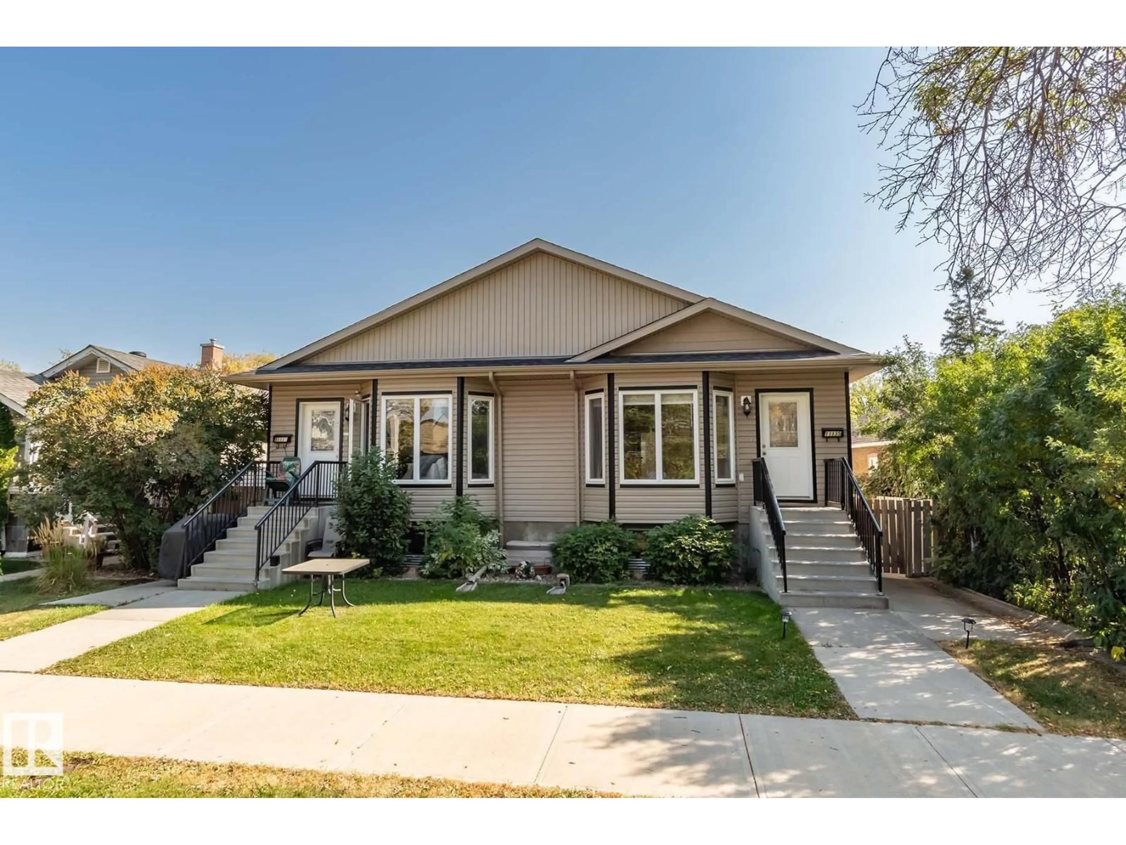 Home with vinyl exterior material, street for 11137 127 ST, Edmonton Alberta T5M0T5