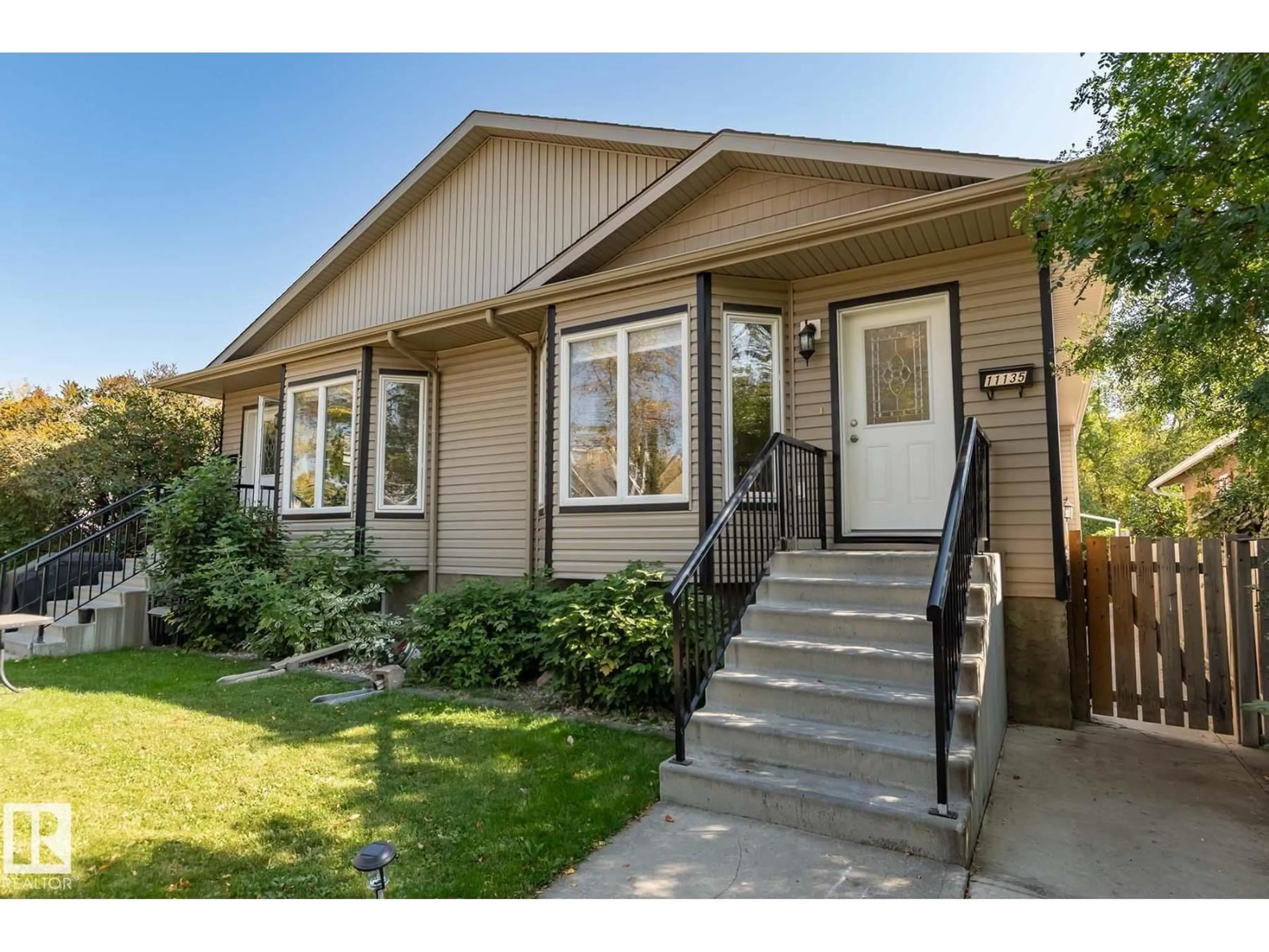 Home with vinyl exterior material, street for 11137 127 ST, Edmonton Alberta T5M0T5
