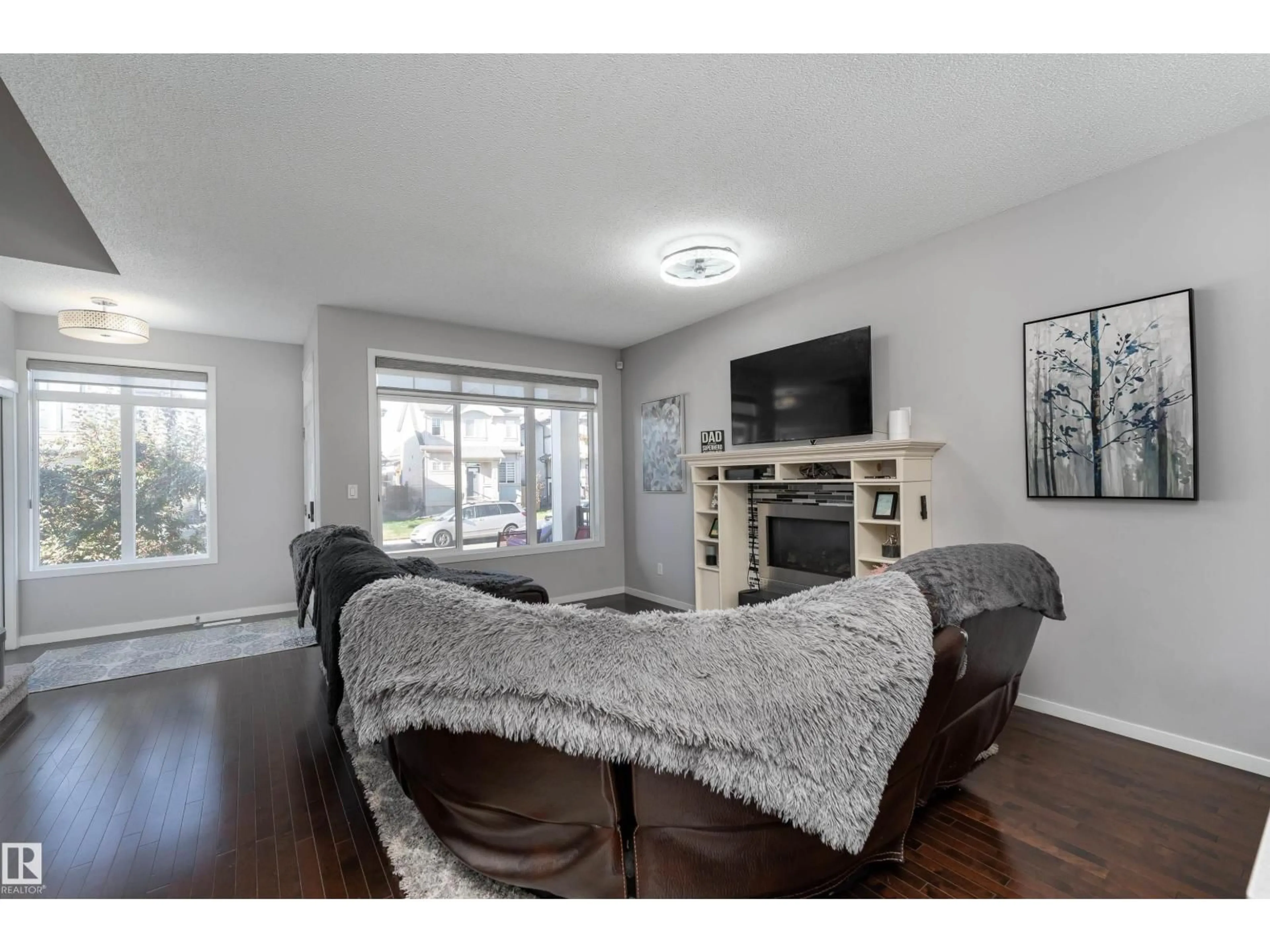 Living room with furniture, wood/laminate floor for NW - 17711 59 ST, Edmonton Alberta T5Y0W8