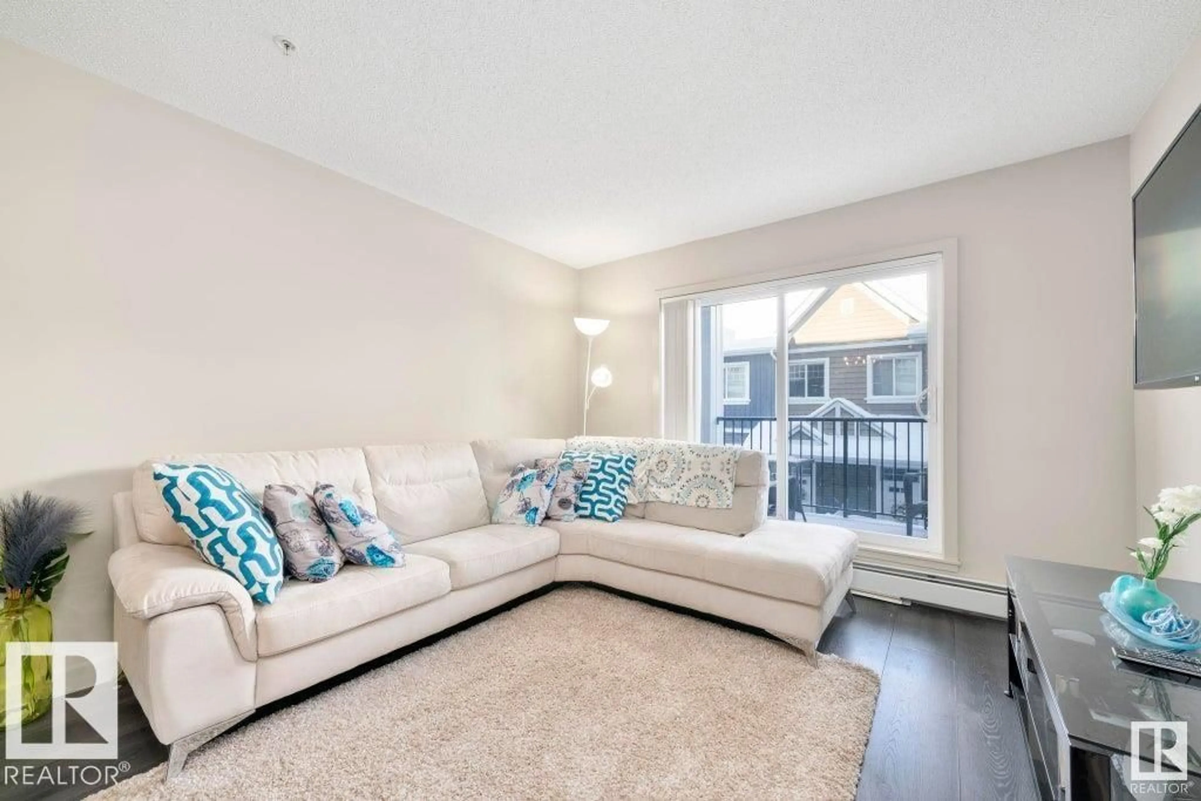 Living room with furniture, unknown for #205 - 4008 SAVARYN DR, Edmonton Alberta T6X2E5