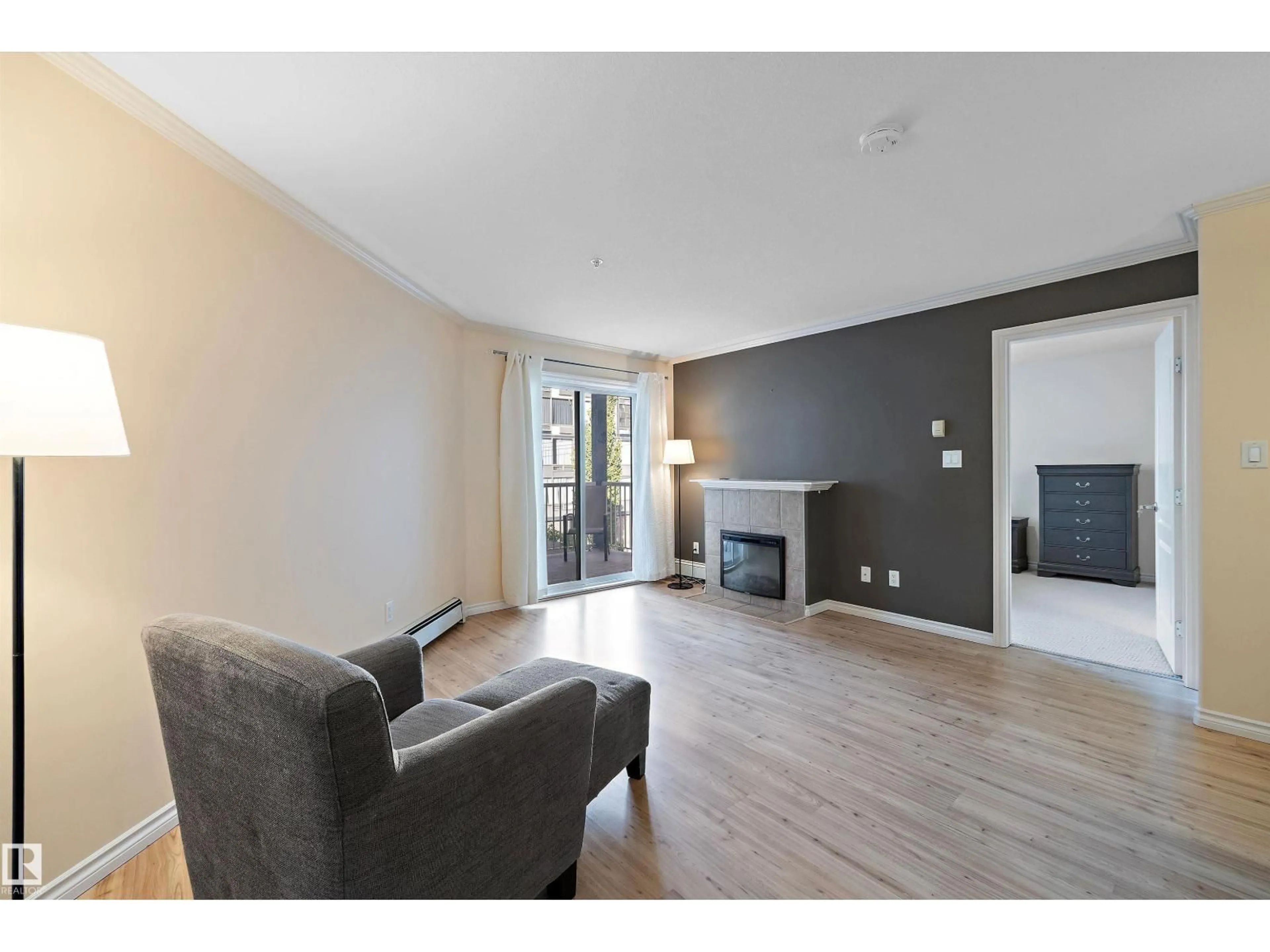 Living room with furniture, wood/laminate floor for 308 - 9938 104 ST NW, Edmonton Alberta T5K2X7
