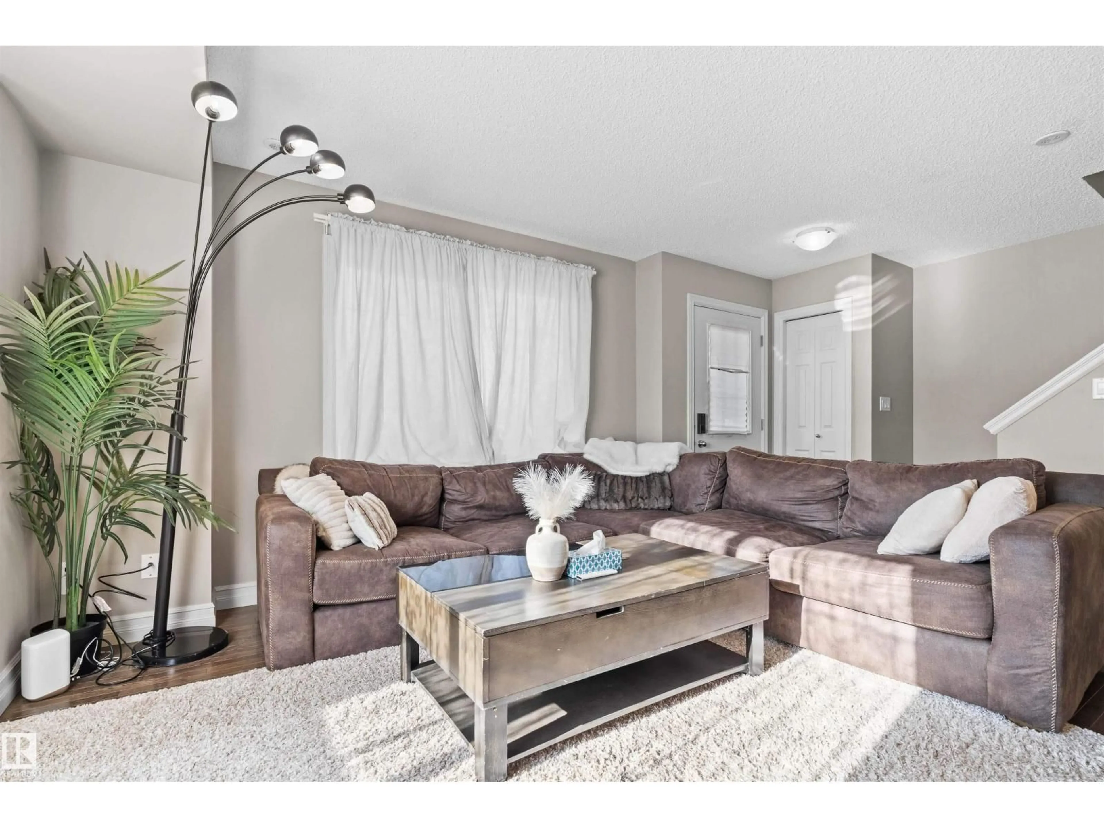 Living room with furniture, wood/laminate floor for 56 5317 3 AV SW, Edmonton Alberta T6X0W7