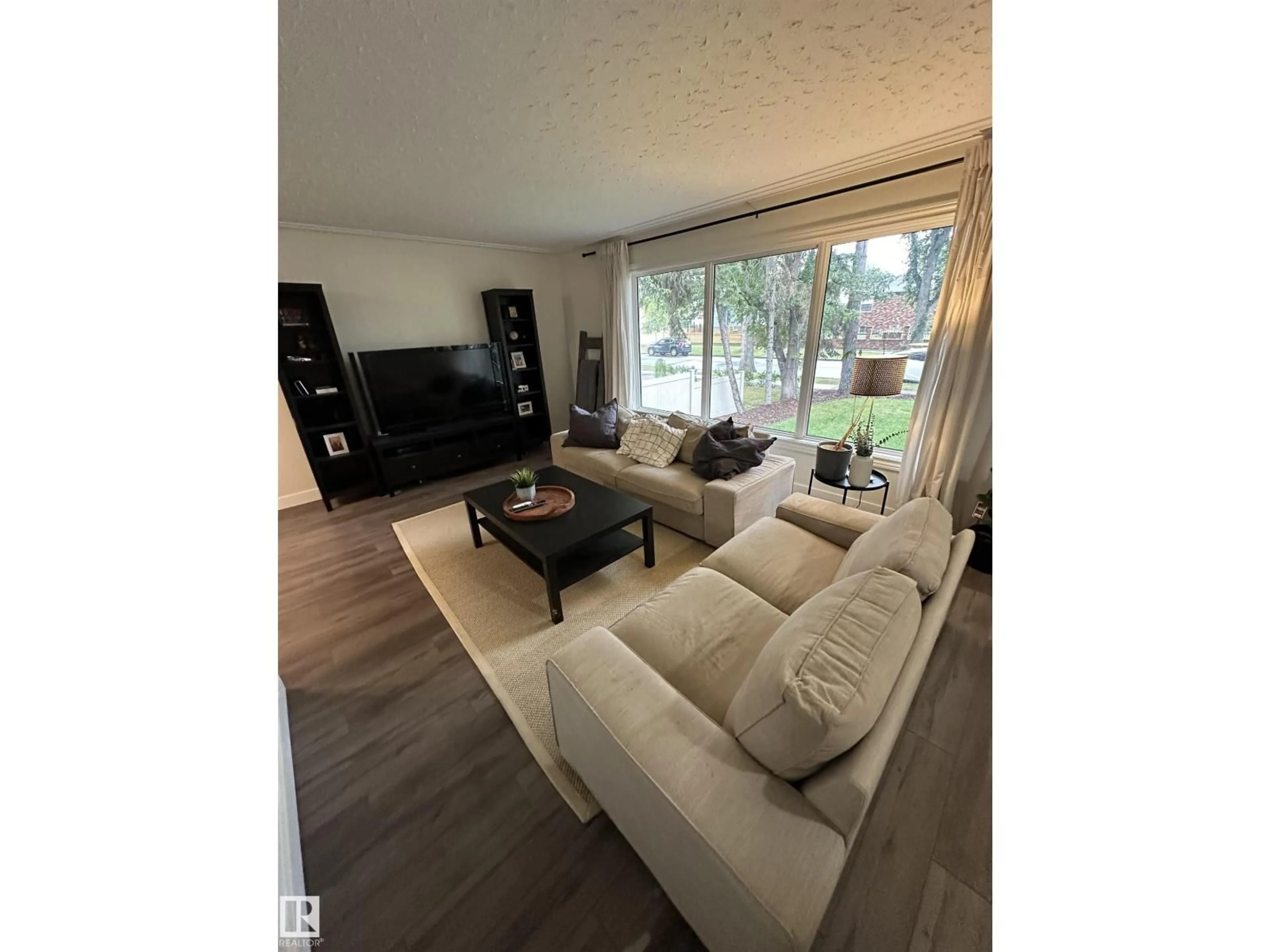 Living room with furniture, wood/laminate floor for 10309 74 ST, Edmonton Alberta T6A2Y4