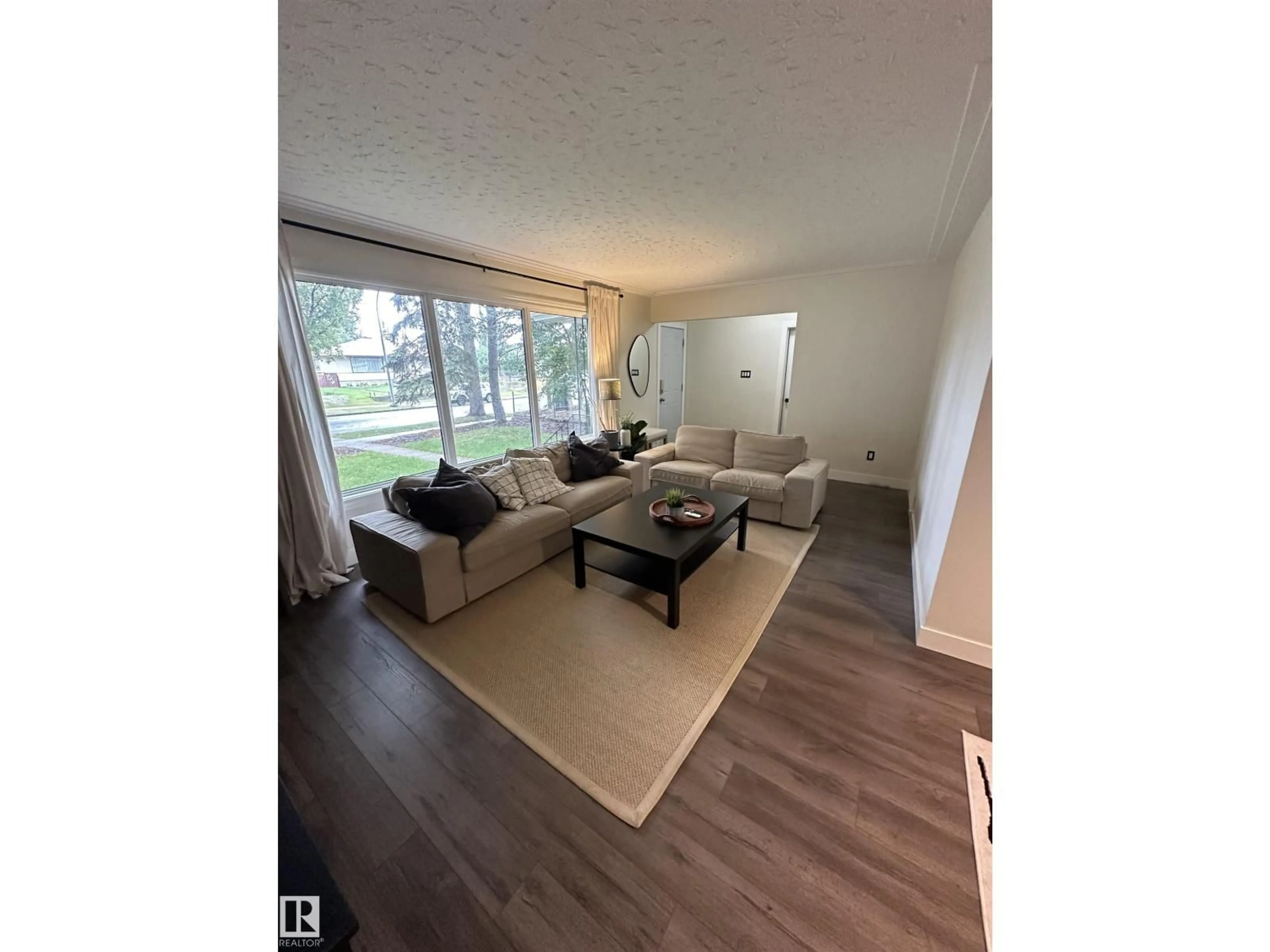 Living room with furniture, wood/laminate floor for 10309 74 ST, Edmonton Alberta T6A2Y4
