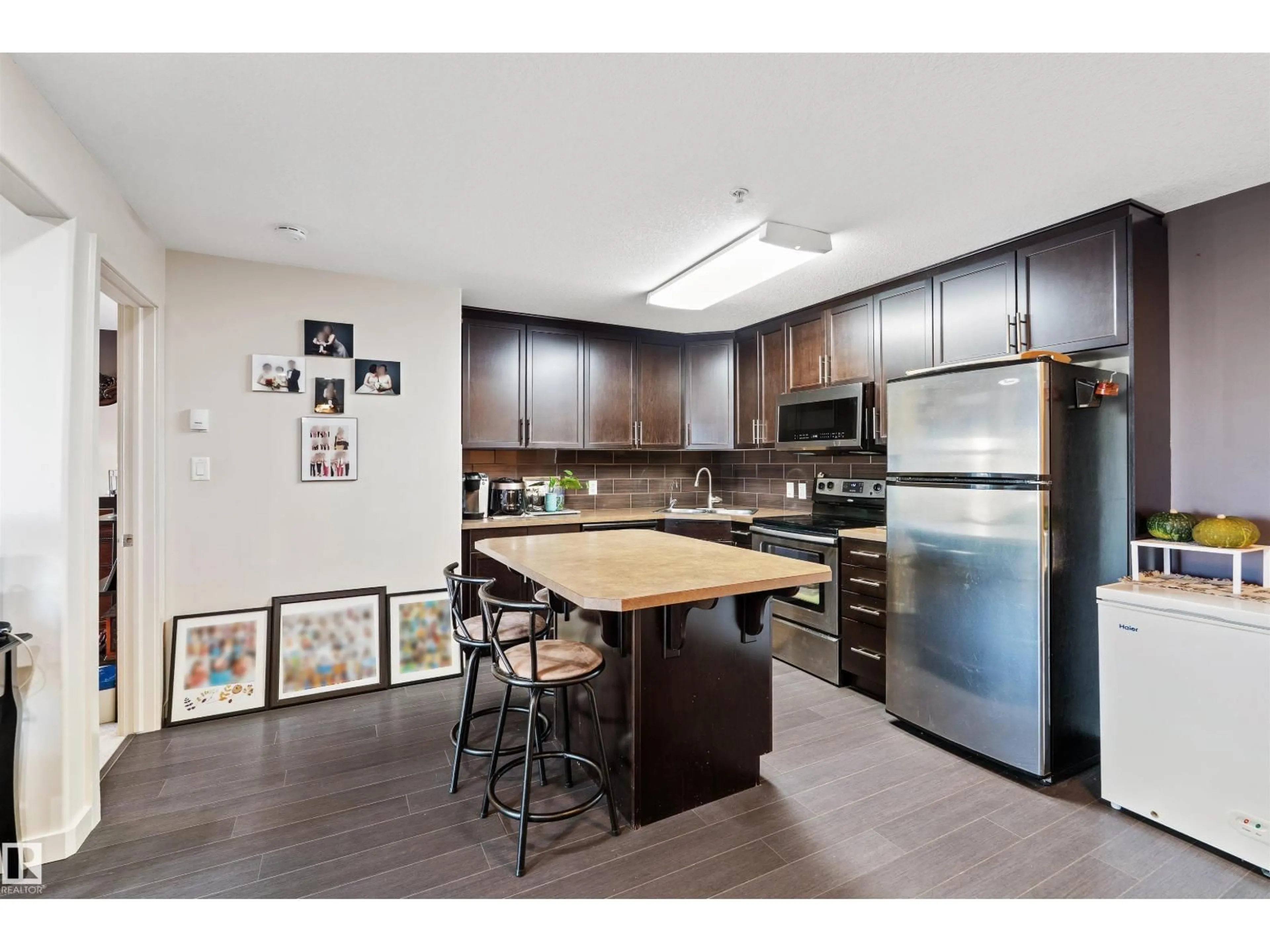 Open concept kitchen, wood/laminate floor for 250 ELLERSLIE RD, Edmonton Alberta T6W2A9
