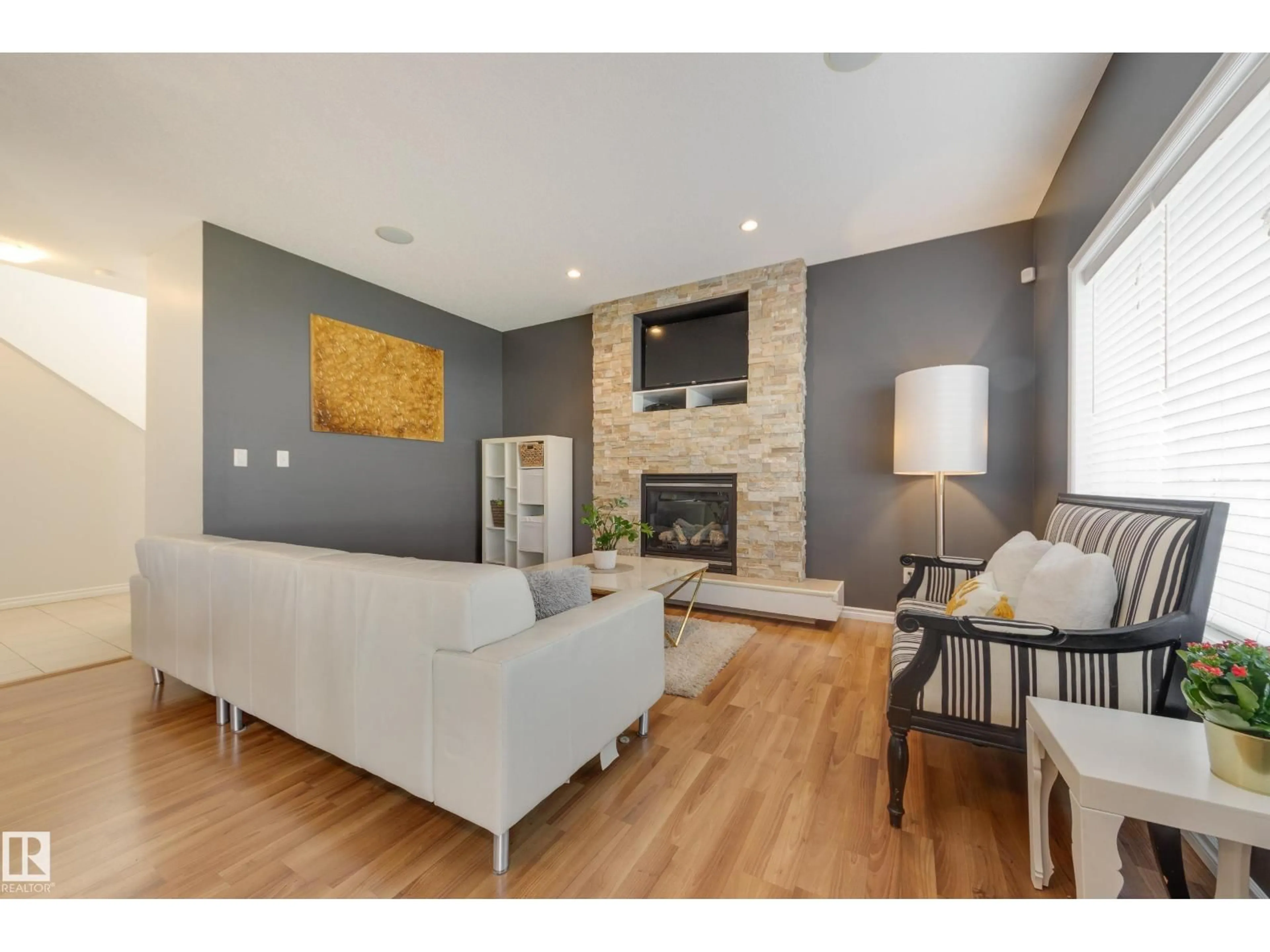 Living room with furniture, wood/laminate floor for 5816 168 AV, Edmonton Alberta T5Y0K6