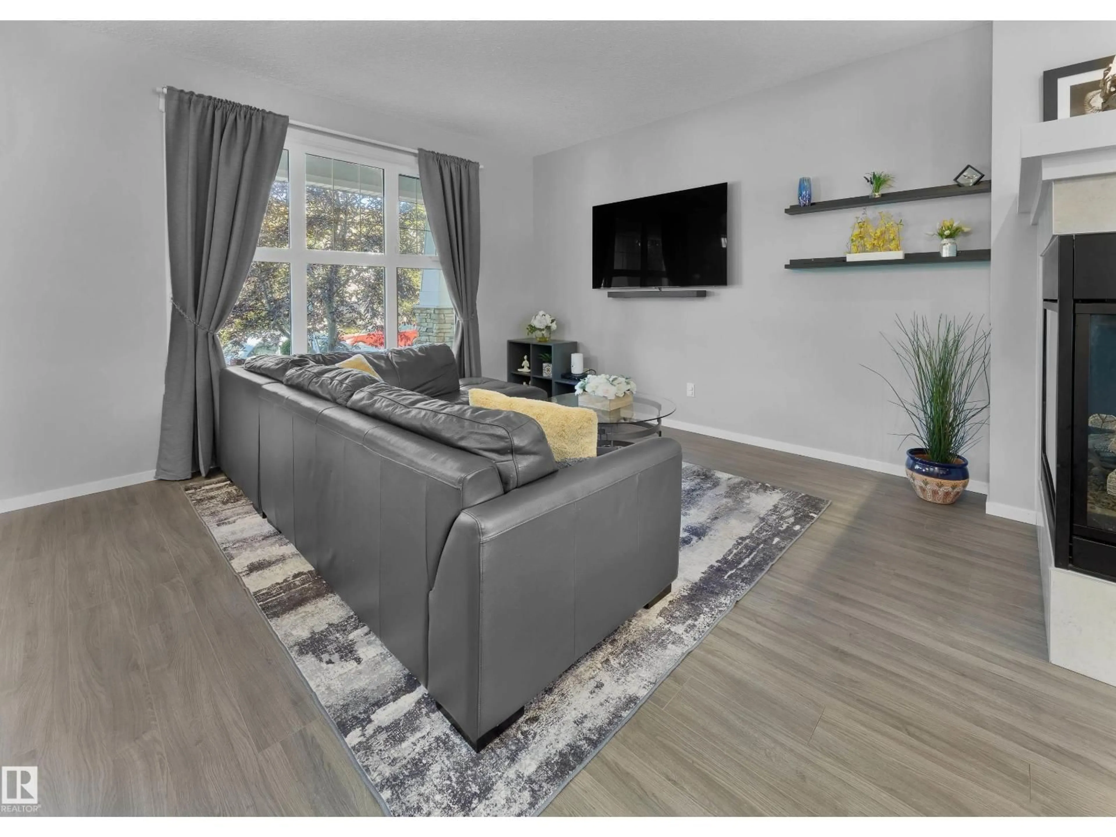 Living room with furniture, wood/laminate floor for 4223 ALLAN LI SW, Edmonton Alberta T6W2K1