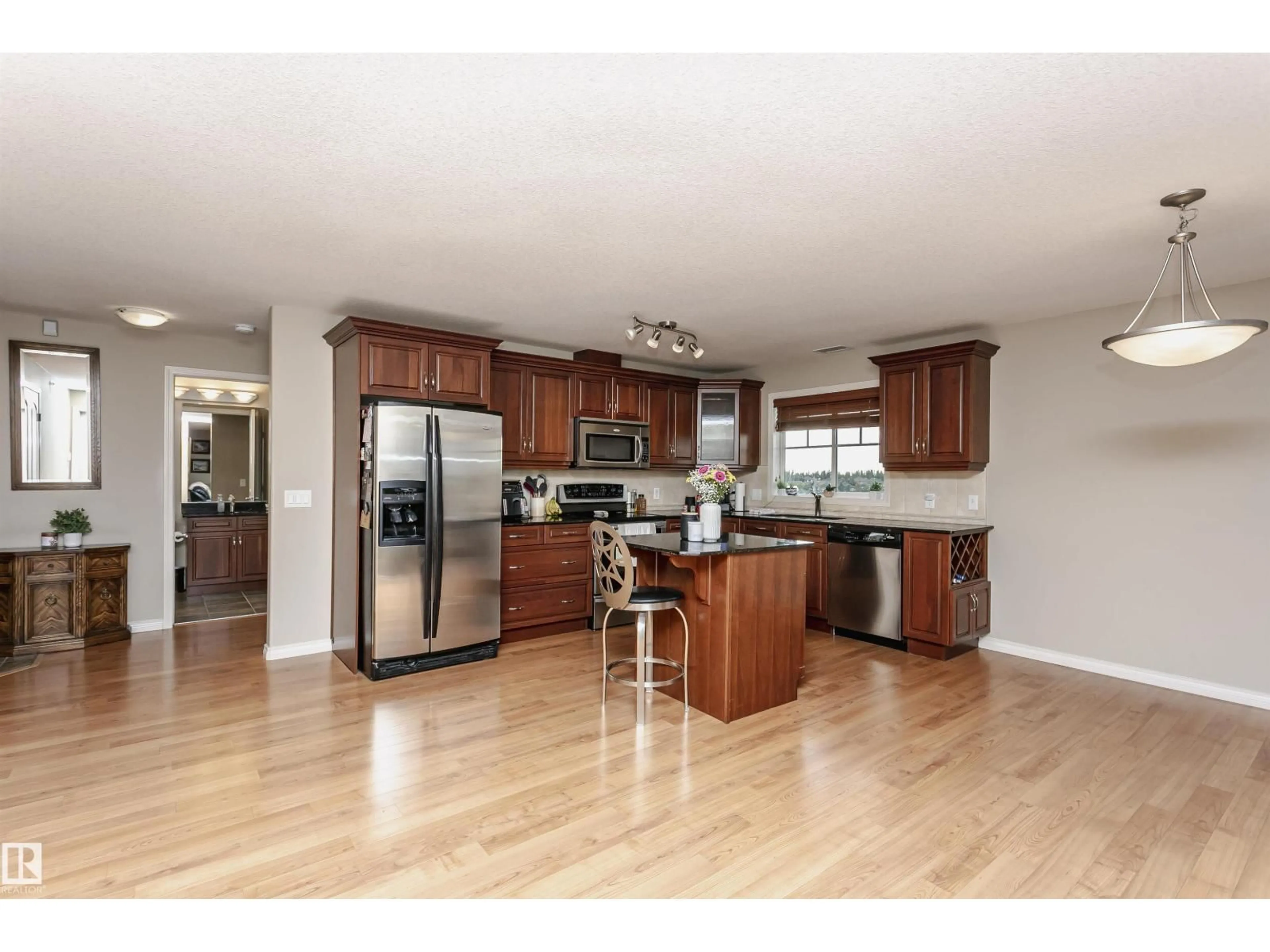 Open concept kitchen, wood/laminate floor for #433 - 2096 BLACKMUD CREEK DR, Edmonton Alberta T6W0G1