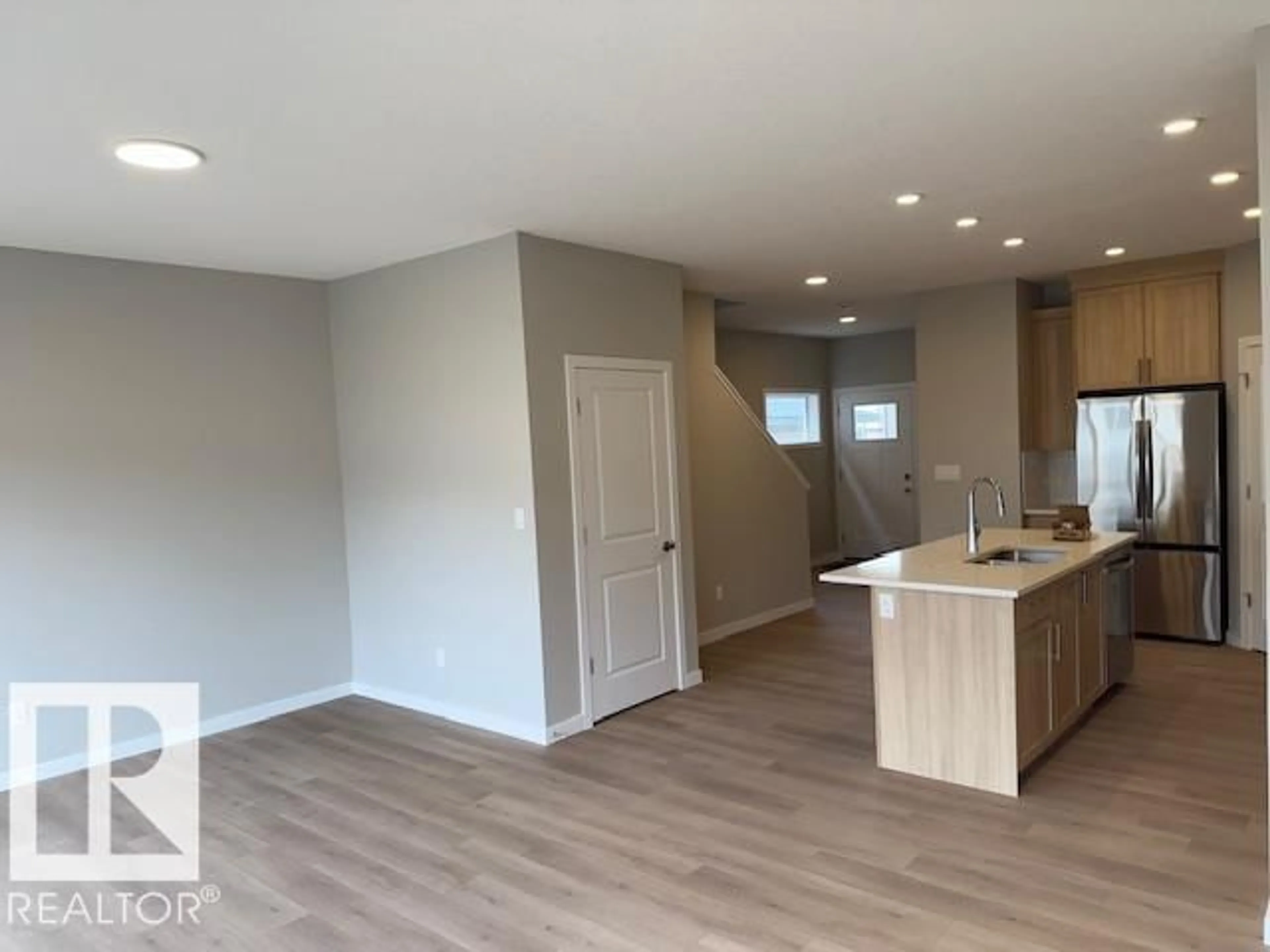 Open concept kitchen, wood/laminate floor for 18111 74 ST, Edmonton Alberta T5Z0X7