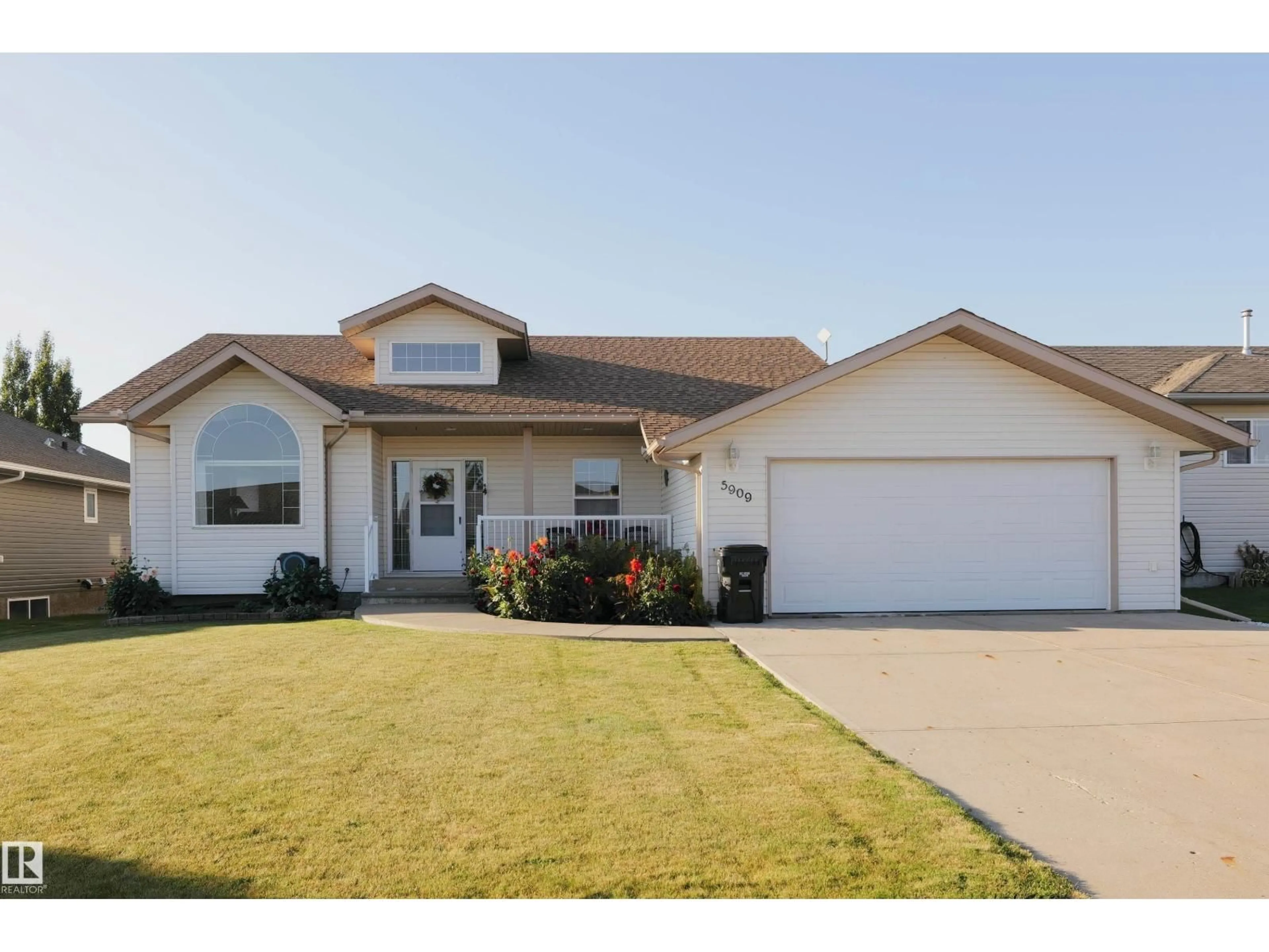 Home with vinyl exterior material, street for 5909 51 AV, Barrhead Alberta T7N1N7