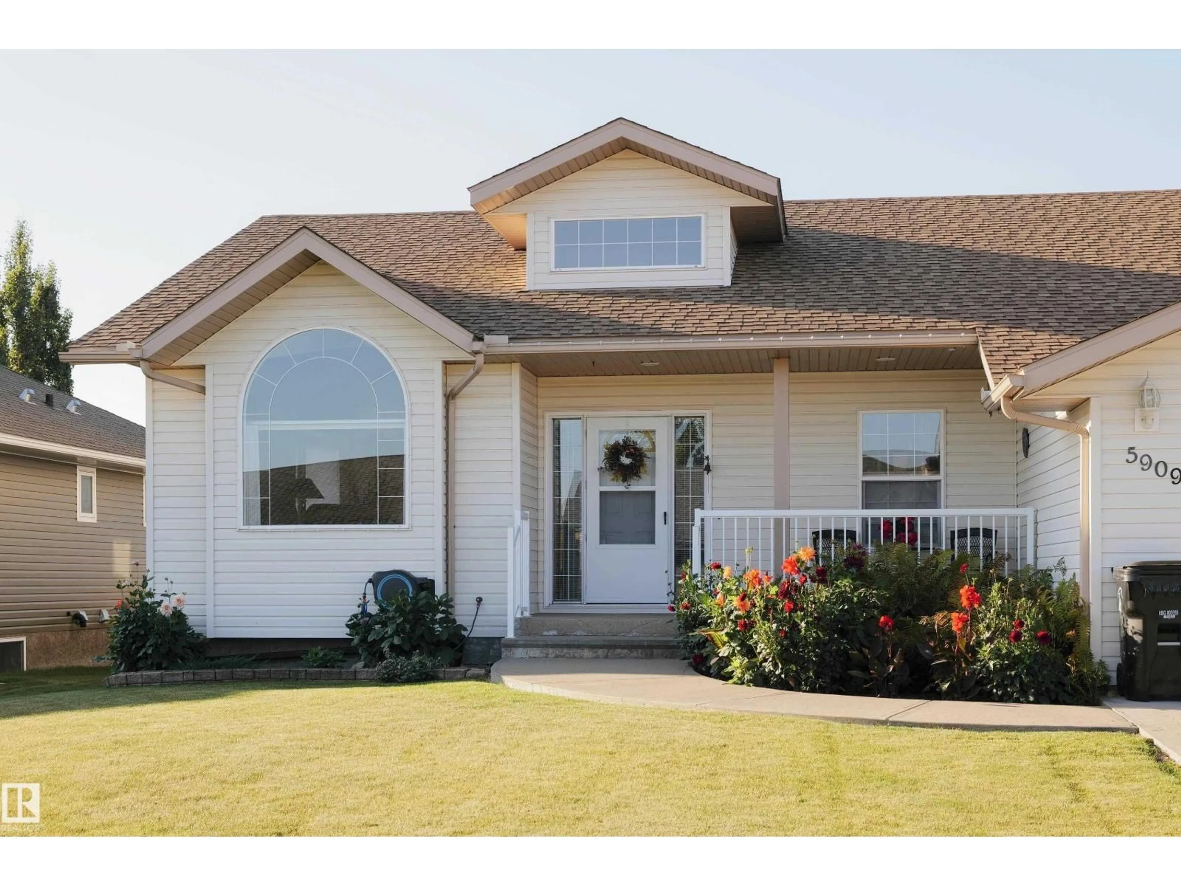 Home with vinyl exterior material, street for 5909 51 AV, Barrhead Alberta T7N1N7