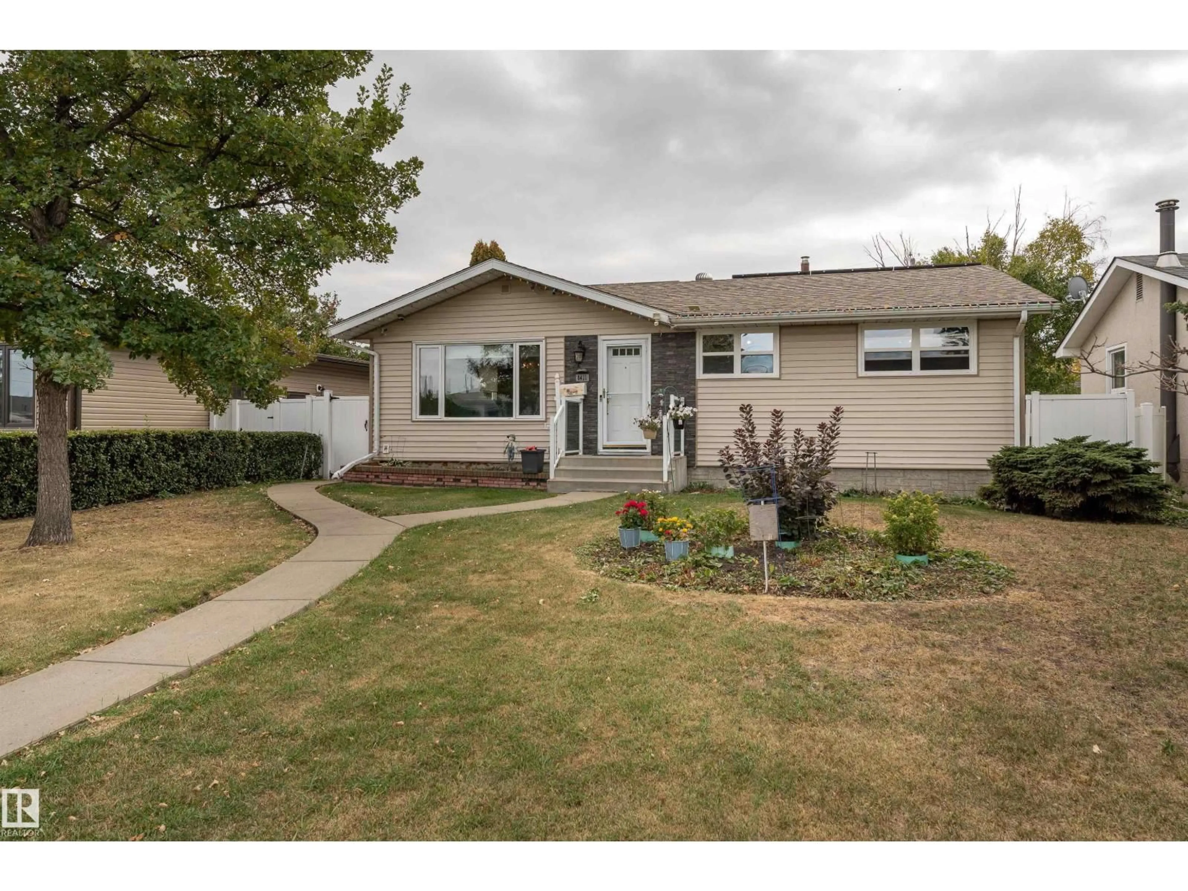 Home with vinyl exterior material, street for 8411 135 AV, Edmonton Alberta T5E1M9