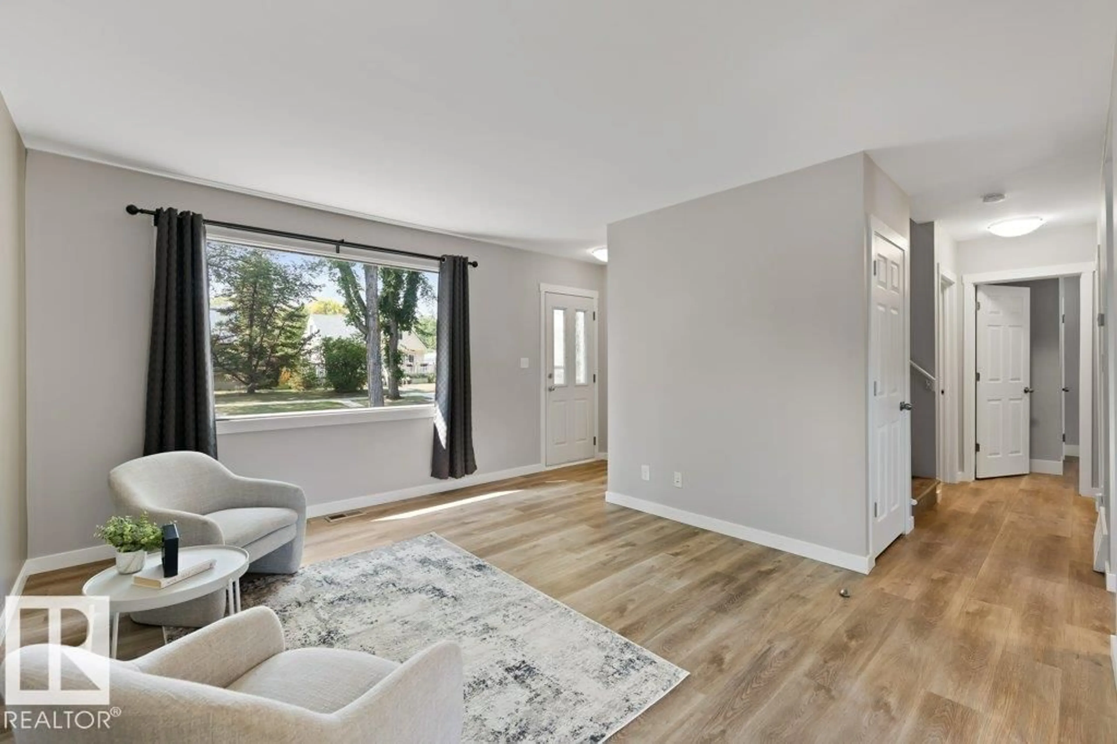 Living room with furniture, wood/laminate floor for 11615 69 ST, Edmonton Alberta T5B1S1