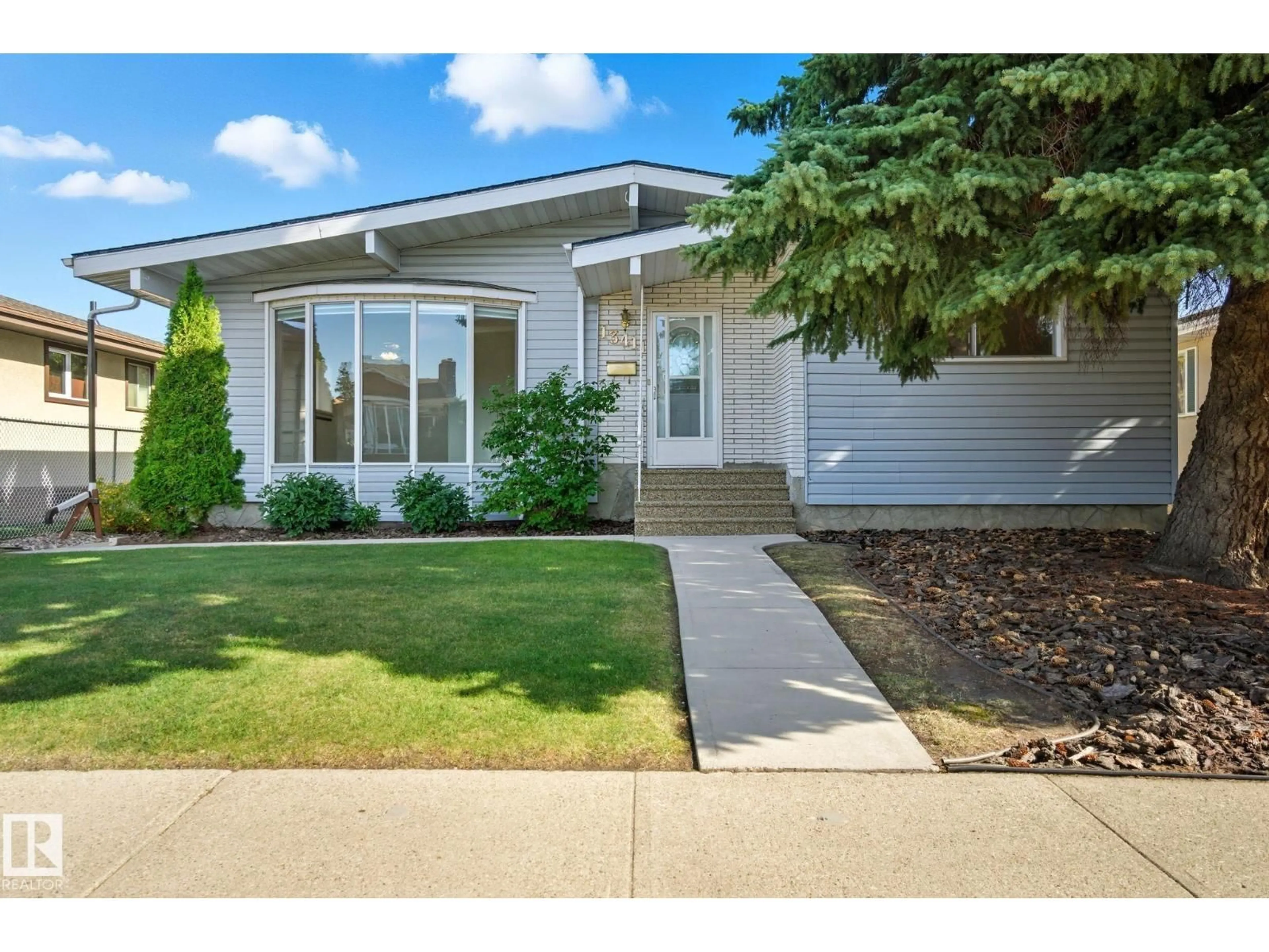 Home with vinyl exterior material, street for 13411 71 ST, Edmonton Alberta T5C0M9
