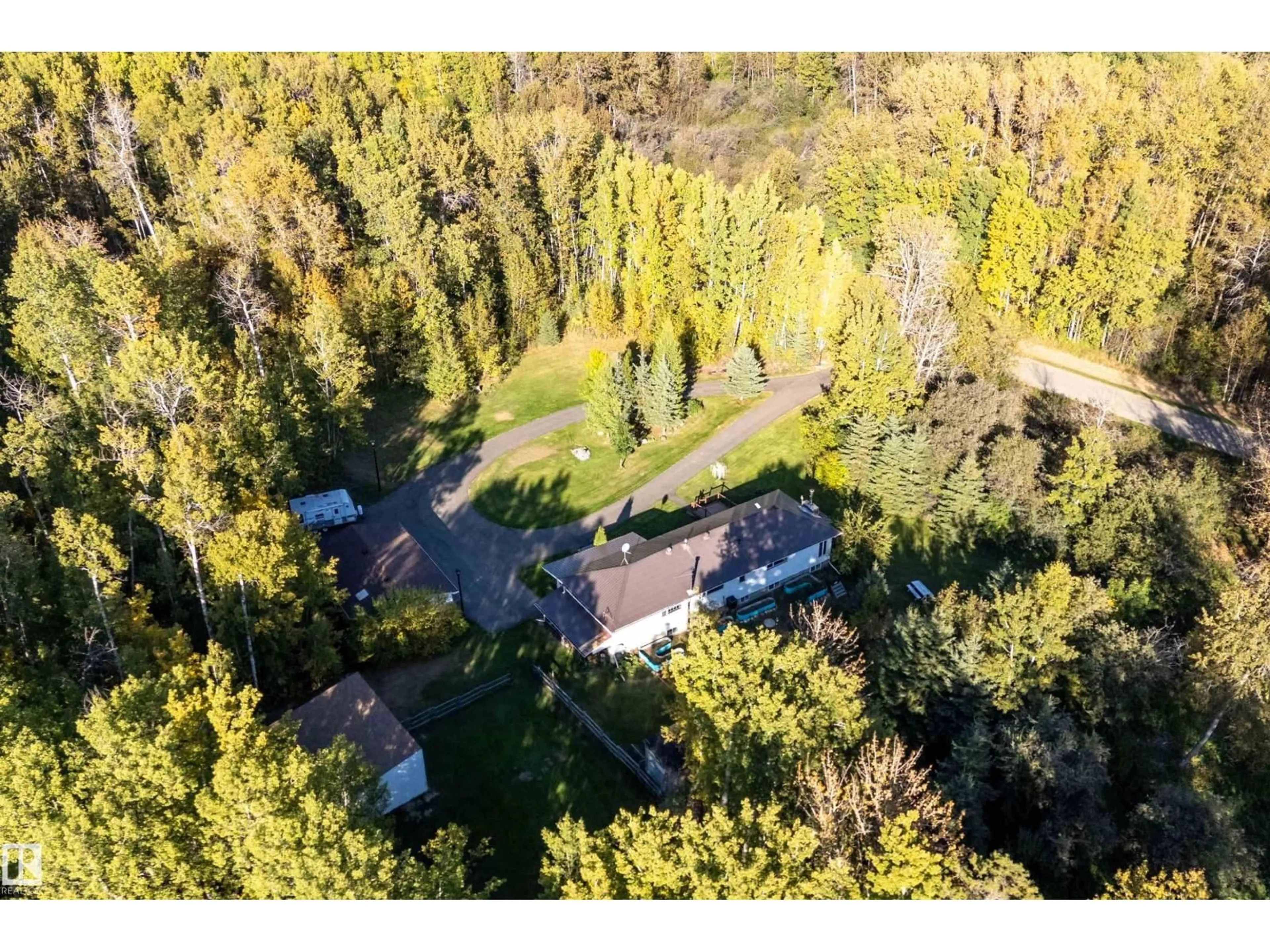 A pic from outside/outdoor area/front of a property/back of a property/a pic from drone, forest/trees view for #4 - 54113 RGE ROAD 13, Rural Parkland County Alberta T7Y0J2
