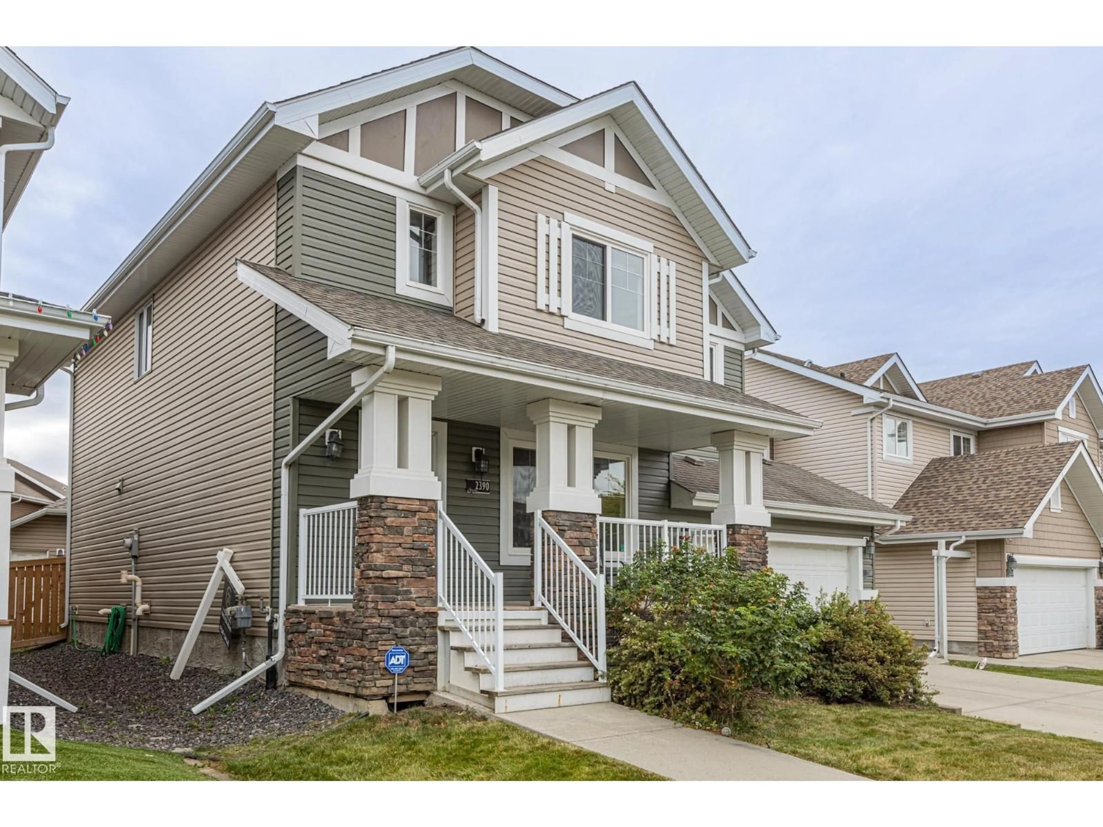 Home with vinyl exterior material, street for 2390 SPARROW CR, Edmonton Alberta T5S0G6