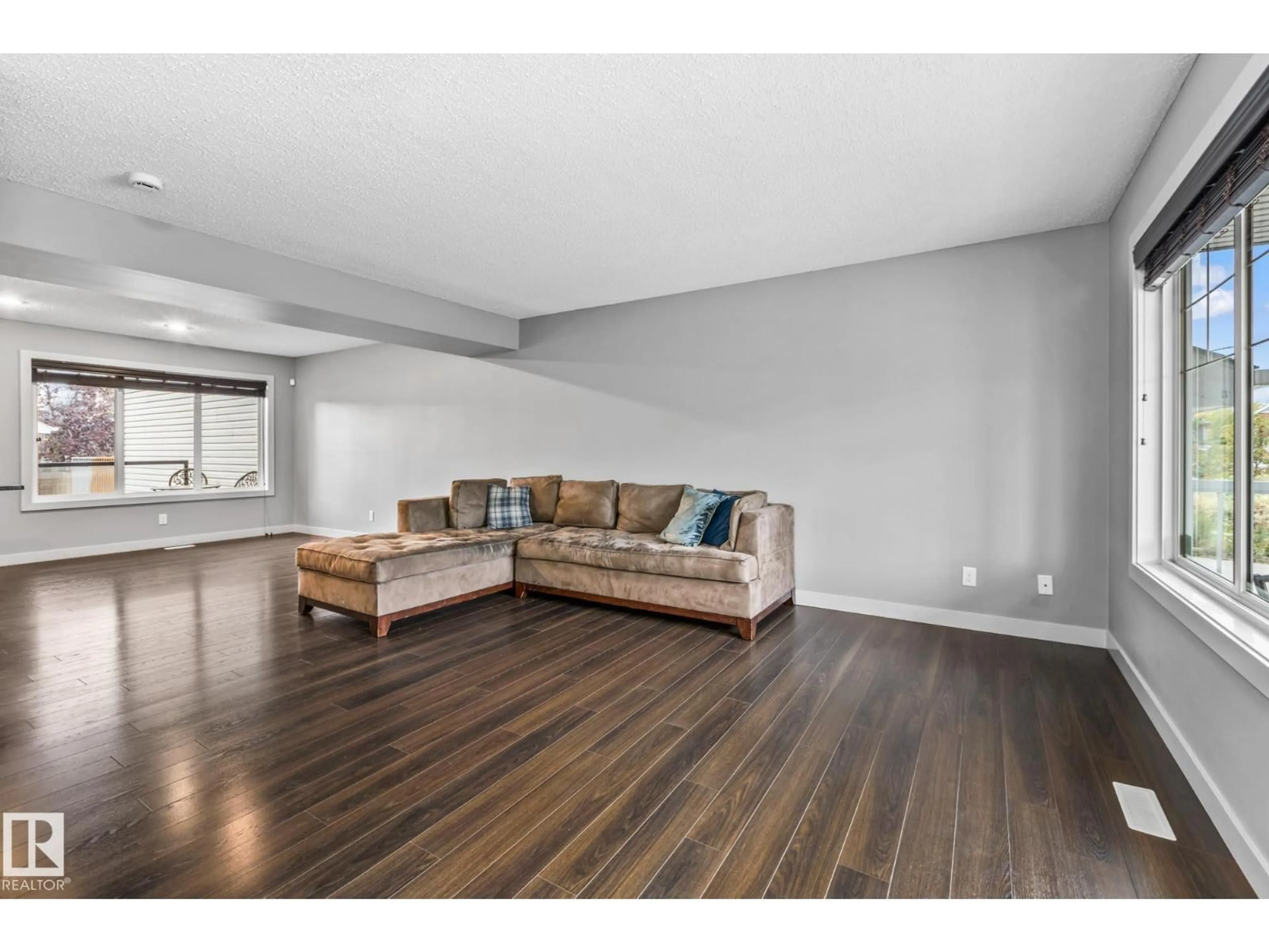 Living room with furniture, wood/laminate floor for 2390 SPARROW CR, Edmonton Alberta T5S0G6
