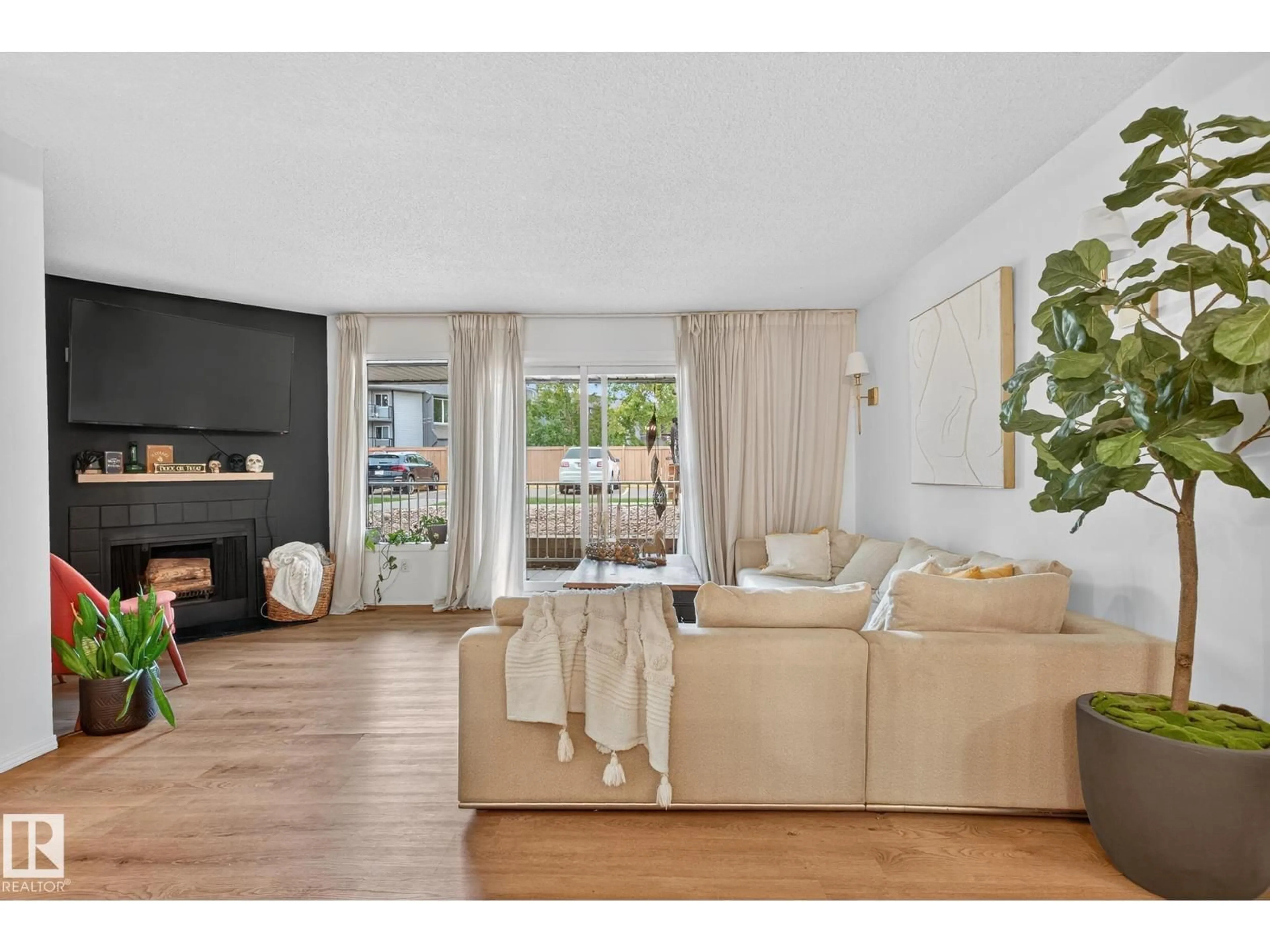 Living room with furniture, wood/laminate floor for 333 - 10404 24 AV, Edmonton Alberta T6J4J7