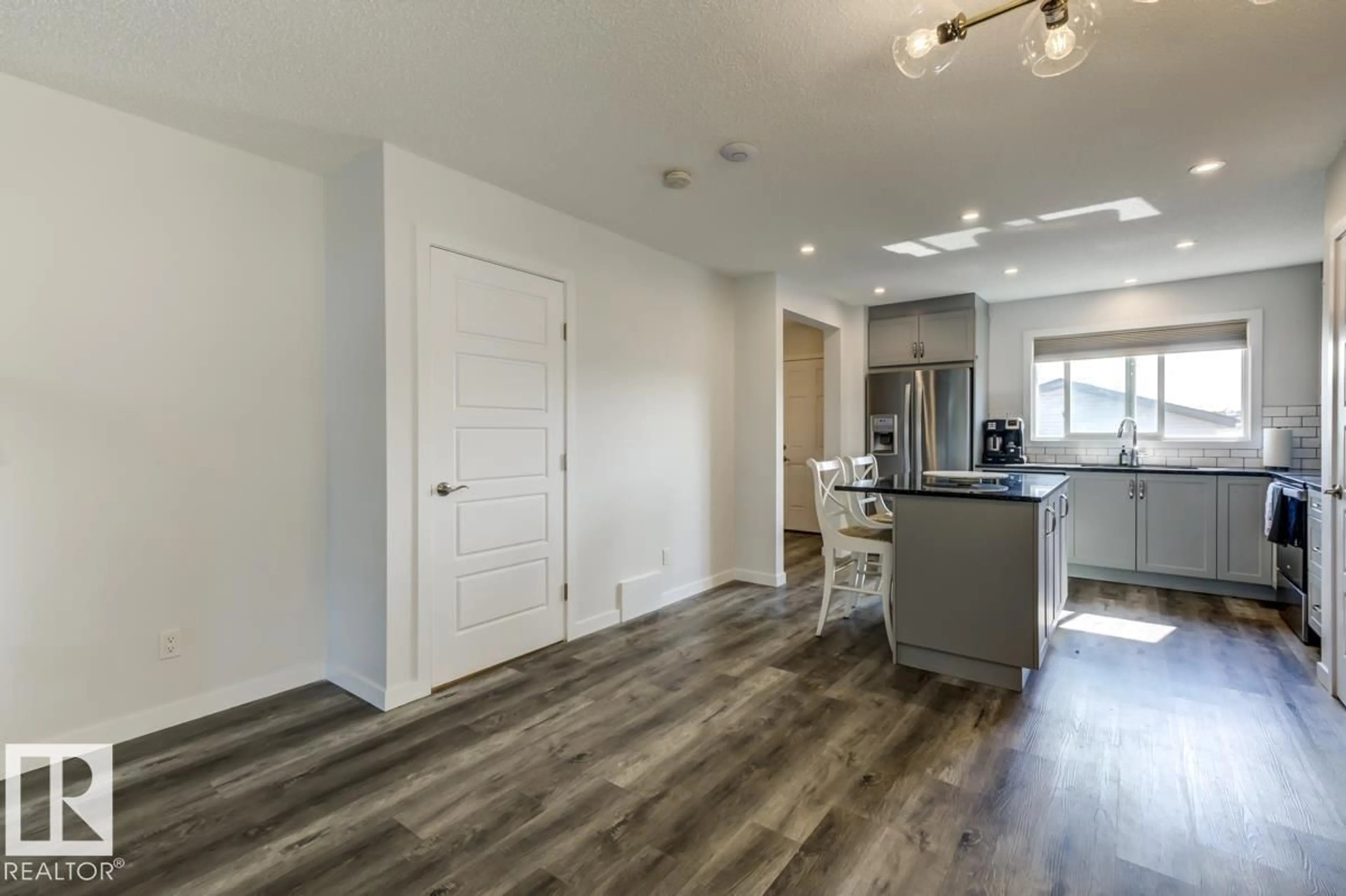 Open concept kitchen, wood/laminate floor for 21007 130 AV, Edmonton Alberta T5S0L4