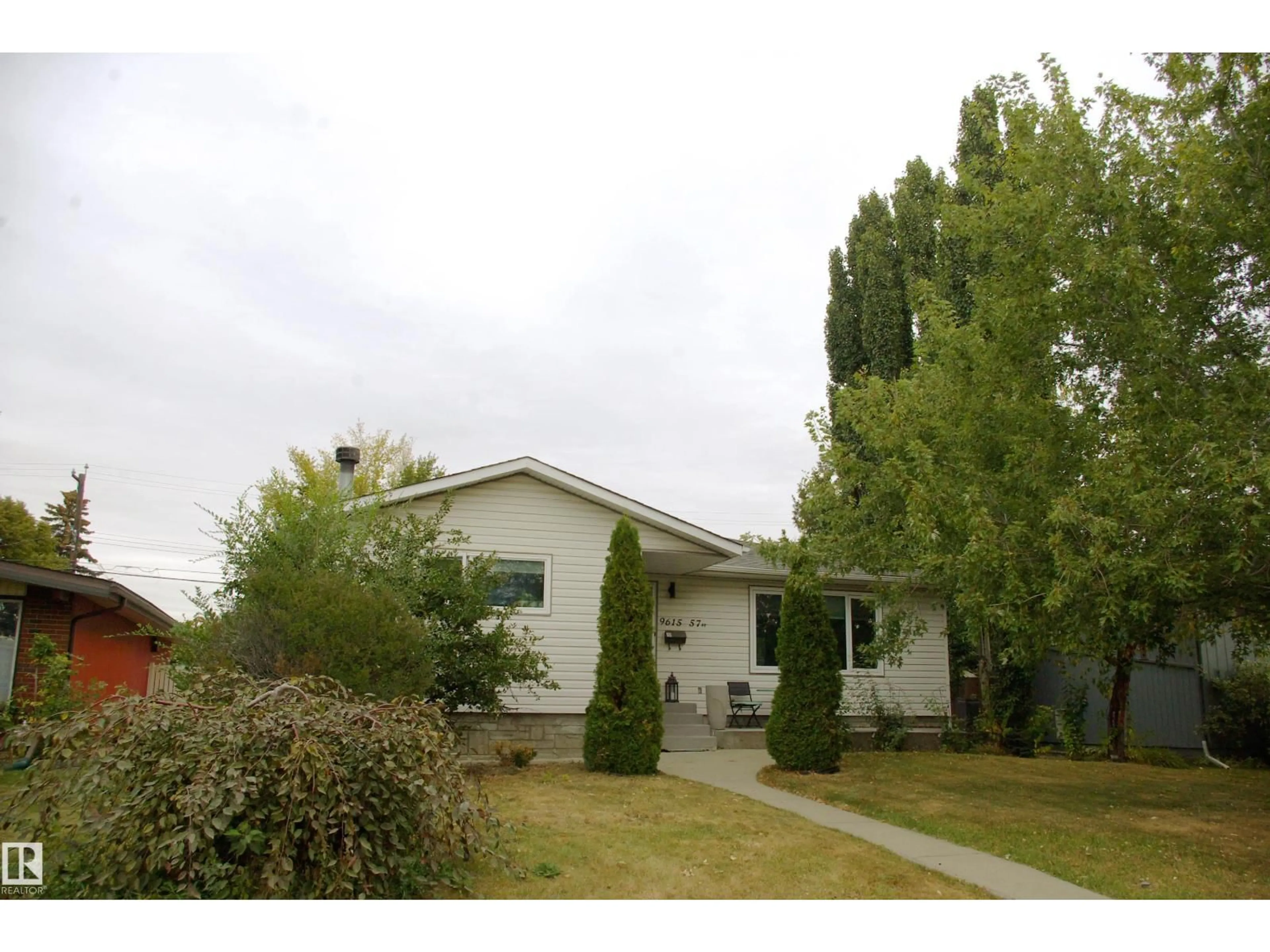 Home with vinyl exterior material, street for NW - 9615 57 ST, Edmonton Alberta T6B1J8