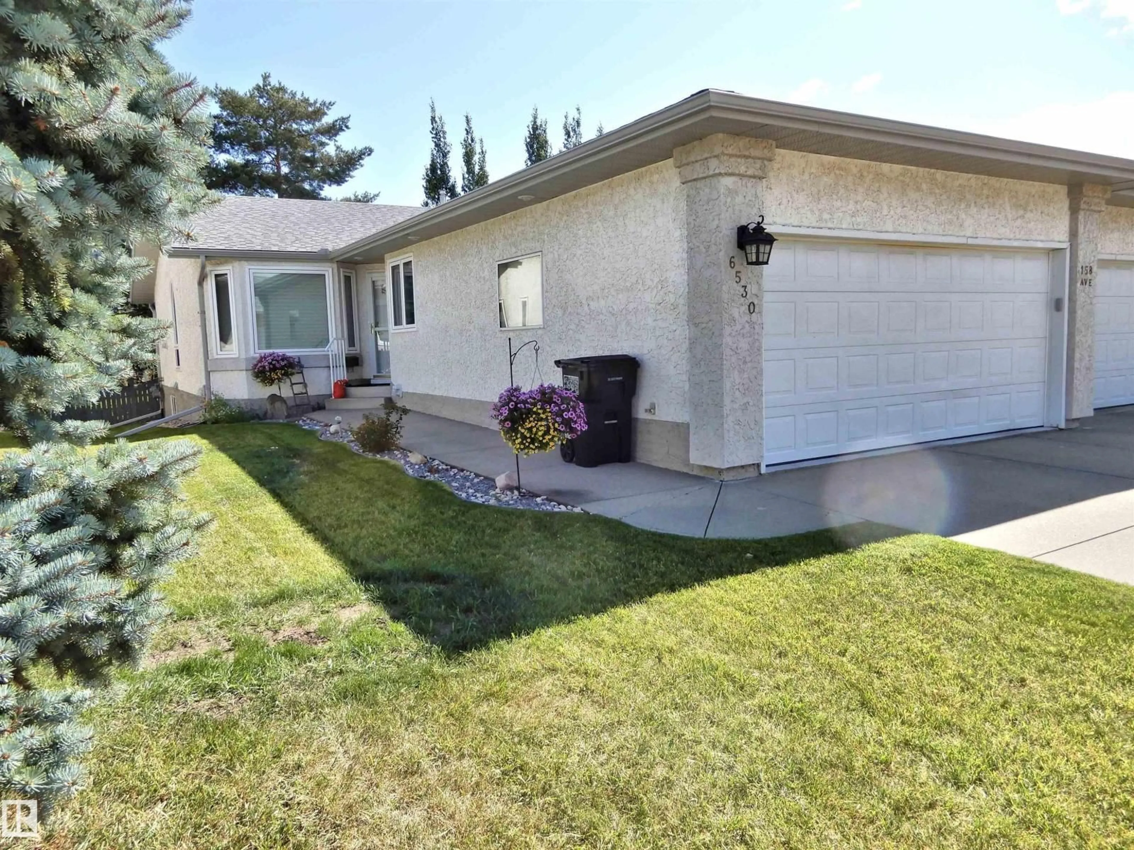Home with vinyl exterior material, street for 6530 158 AV, Edmonton Alberta T5Y2S7