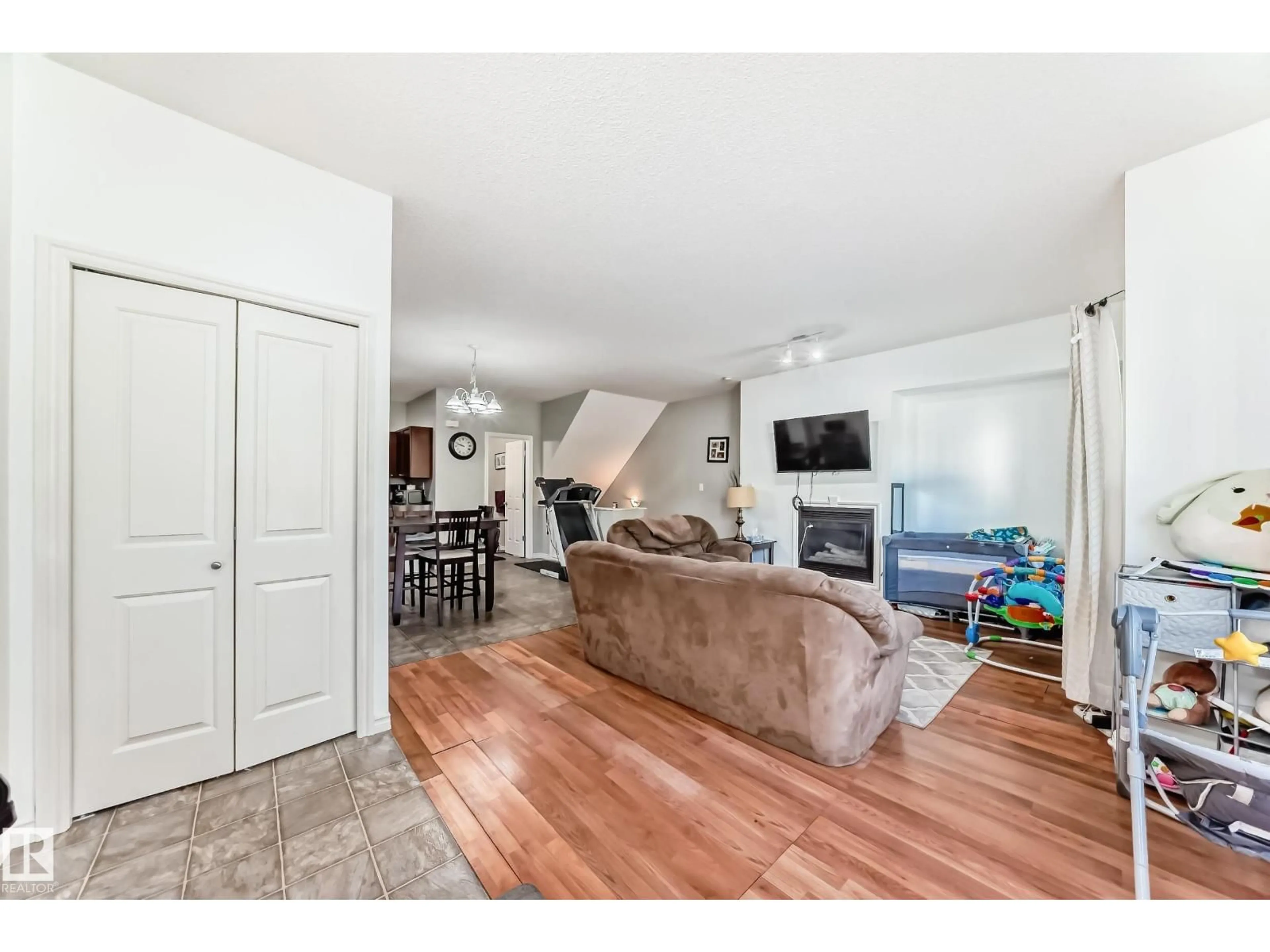 Living room with furniture, wood/laminate floor for #115 - 3010 33 AV, Edmonton Alberta T6T0C3