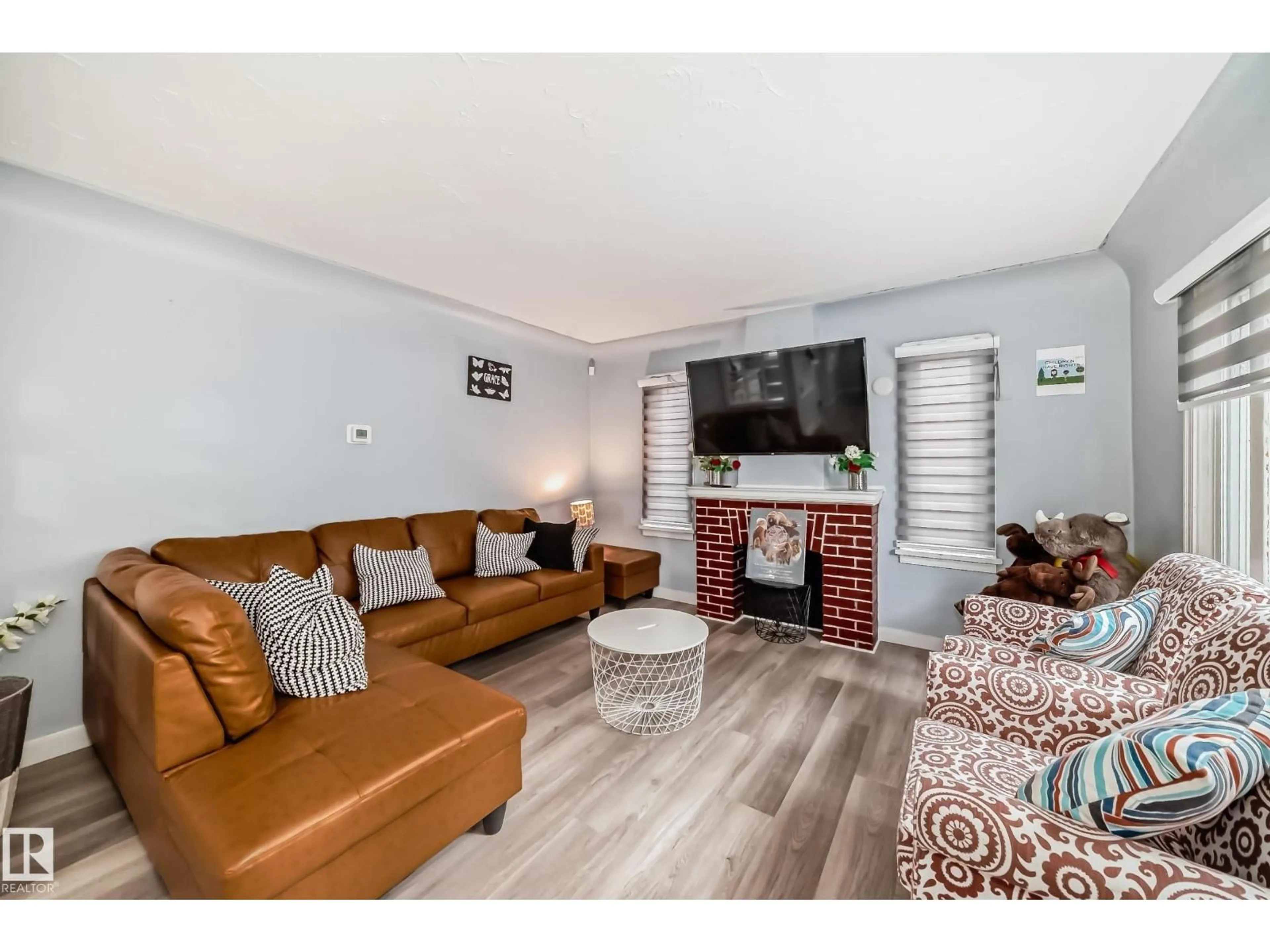 Living room with furniture, wood/laminate floor for NW - 11951 77 ST, Edmonton Alberta T5B2G5