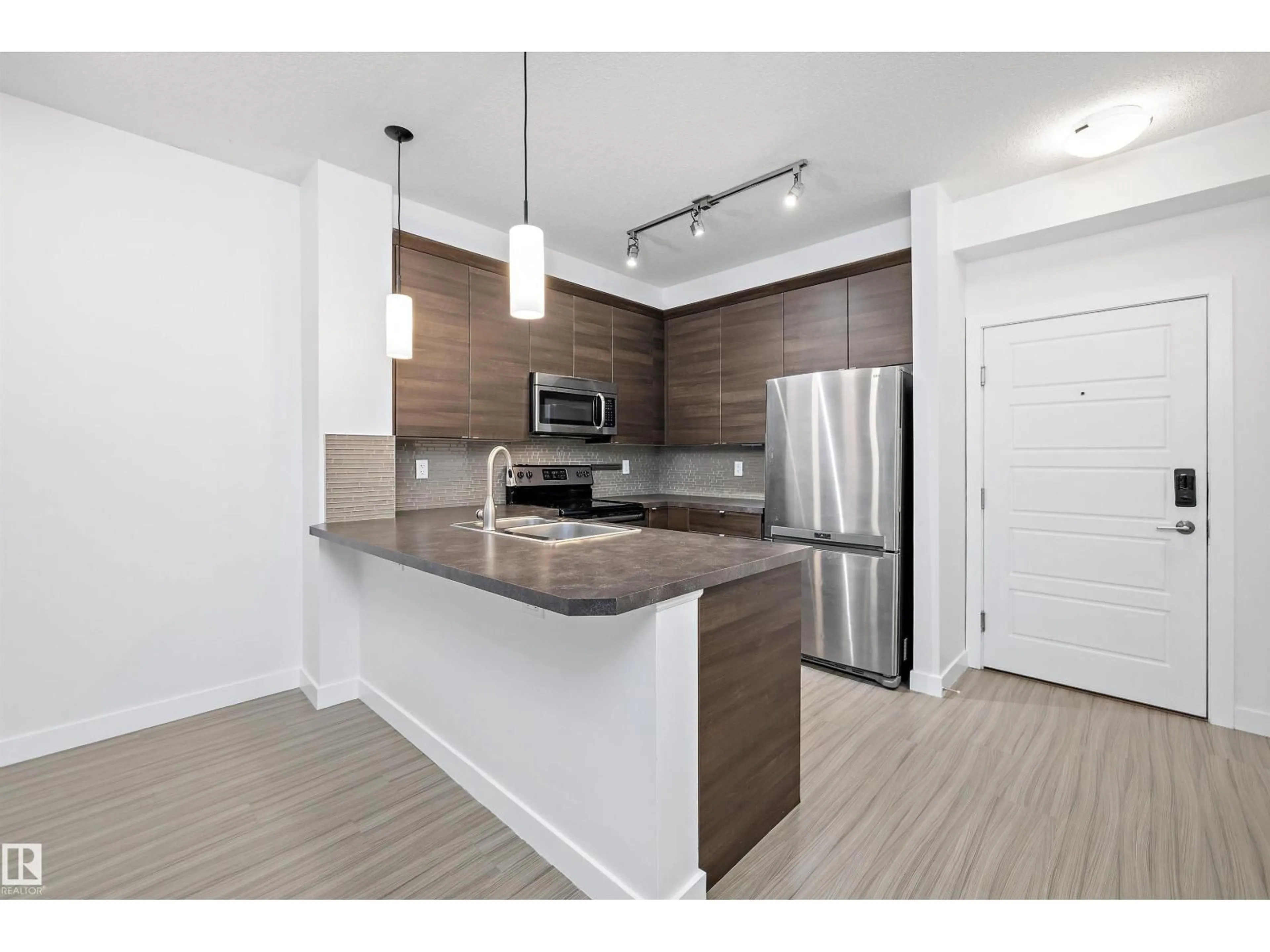 Open concept kitchen, wood/laminate floor for #108 - 2590 ANDERSON WY, Edmonton Alberta T6W0R2