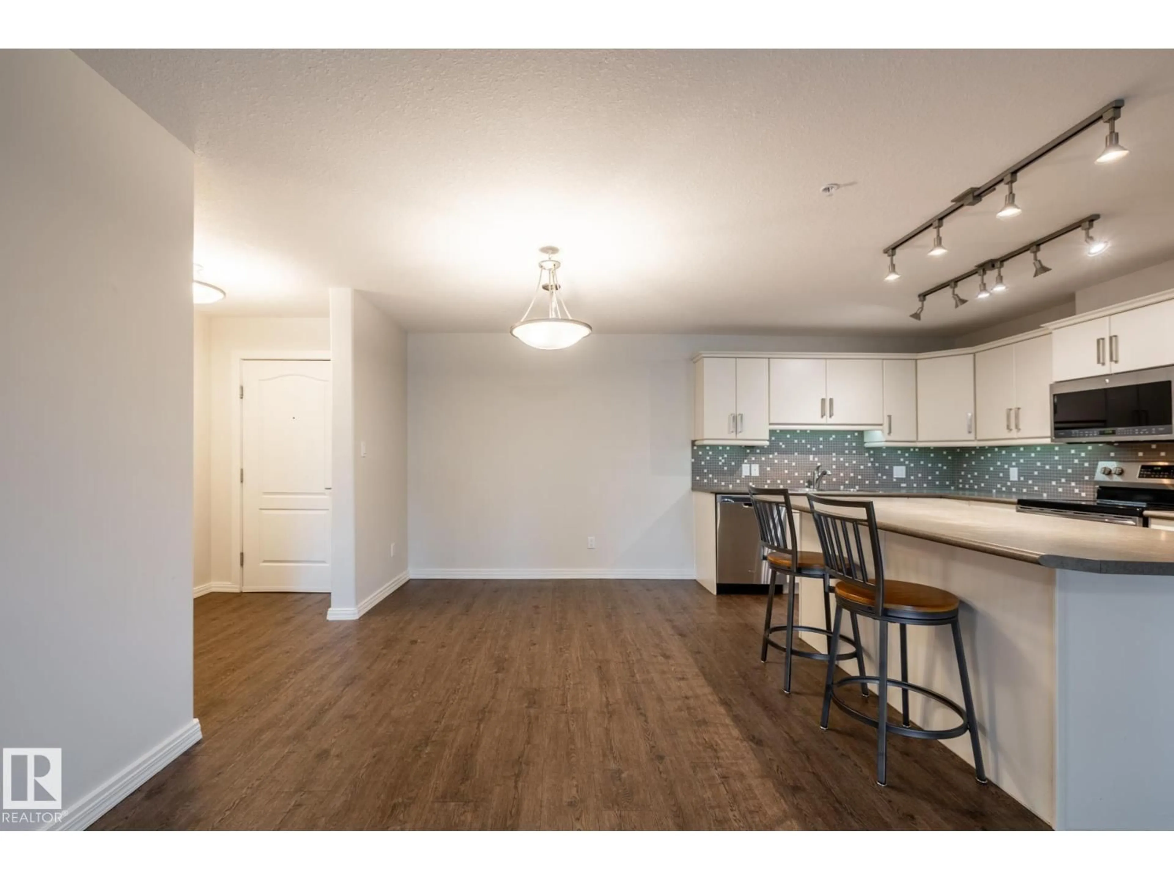 Open concept kitchen, wood/laminate floor for 136 278 SUDER GREENS DR, Edmonton Alberta T5T6V6