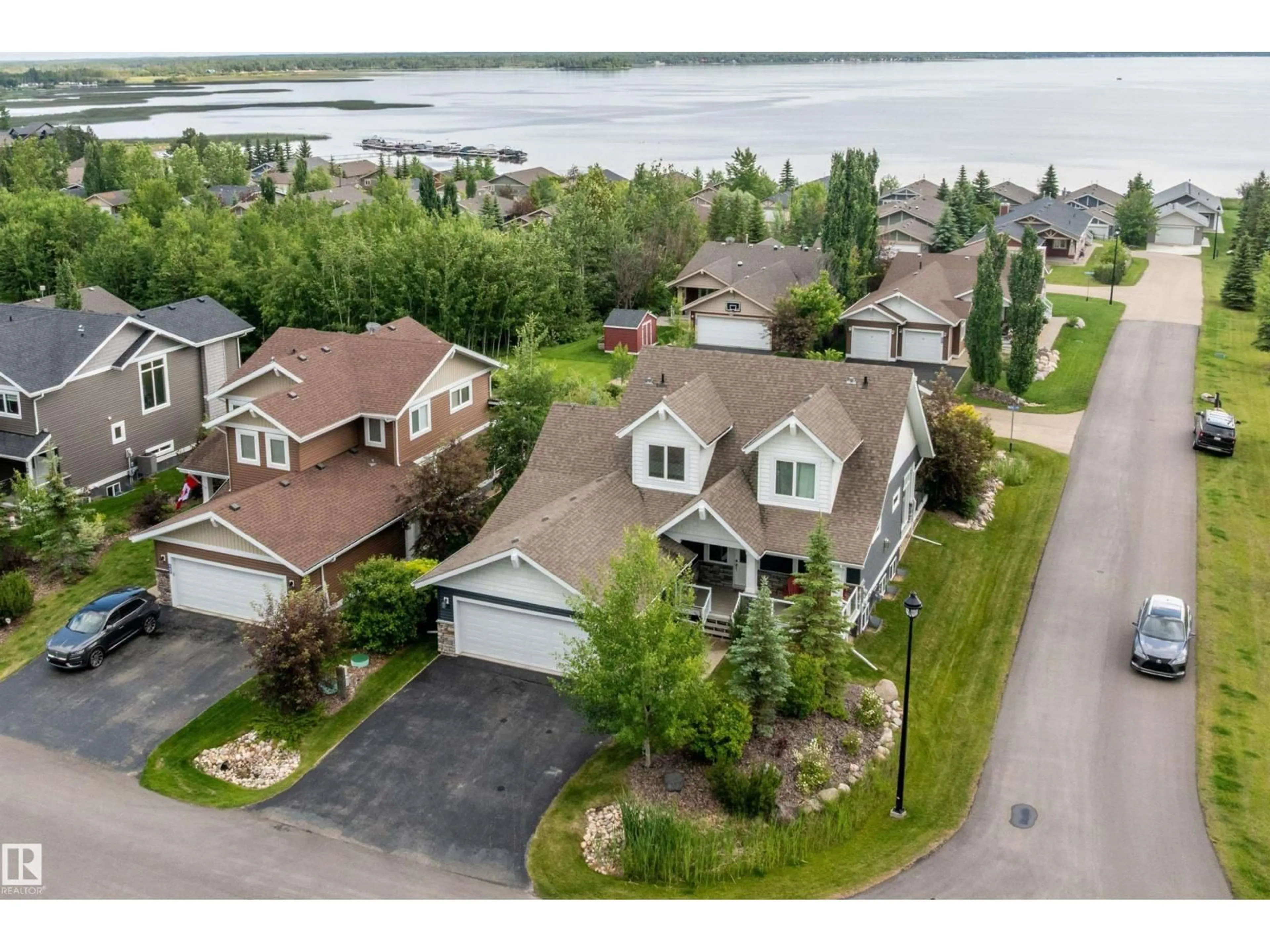 A pic from outside/outdoor area/front of a property/back of a property/a pic from drone, water/lake/river/ocean view for 55101 - 547 STE. ANNE TR, Rural Lac Ste. Anne County Alberta T0E1A1