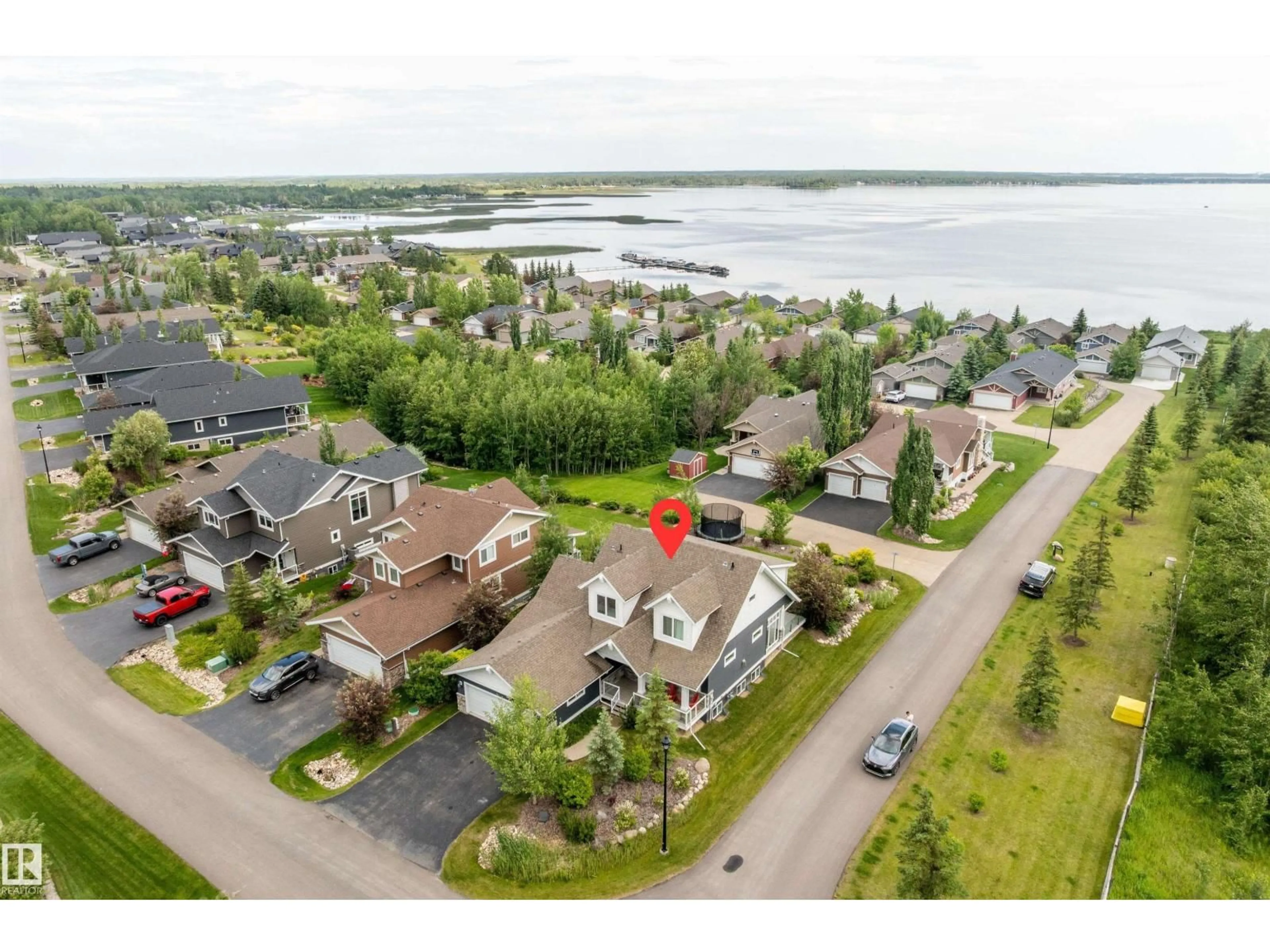 A pic from outside/outdoor area/front of a property/back of a property/a pic from drone, water/lake/river/ocean view for 55101 - 547 STE. ANNE TR, Rural Lac Ste. Anne County Alberta T0E1A1