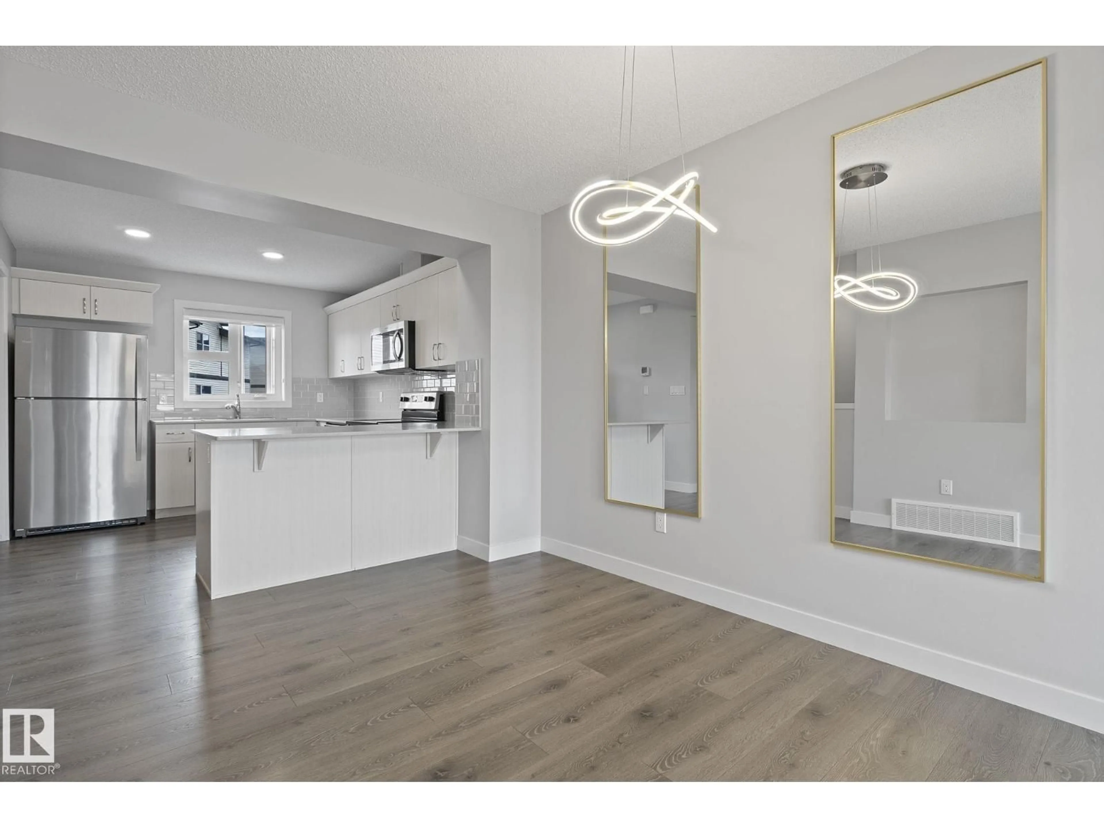 Open concept kitchen, wood/laminate floor for 53 - 1203 163 ST, Edmonton Alberta T6W3X1