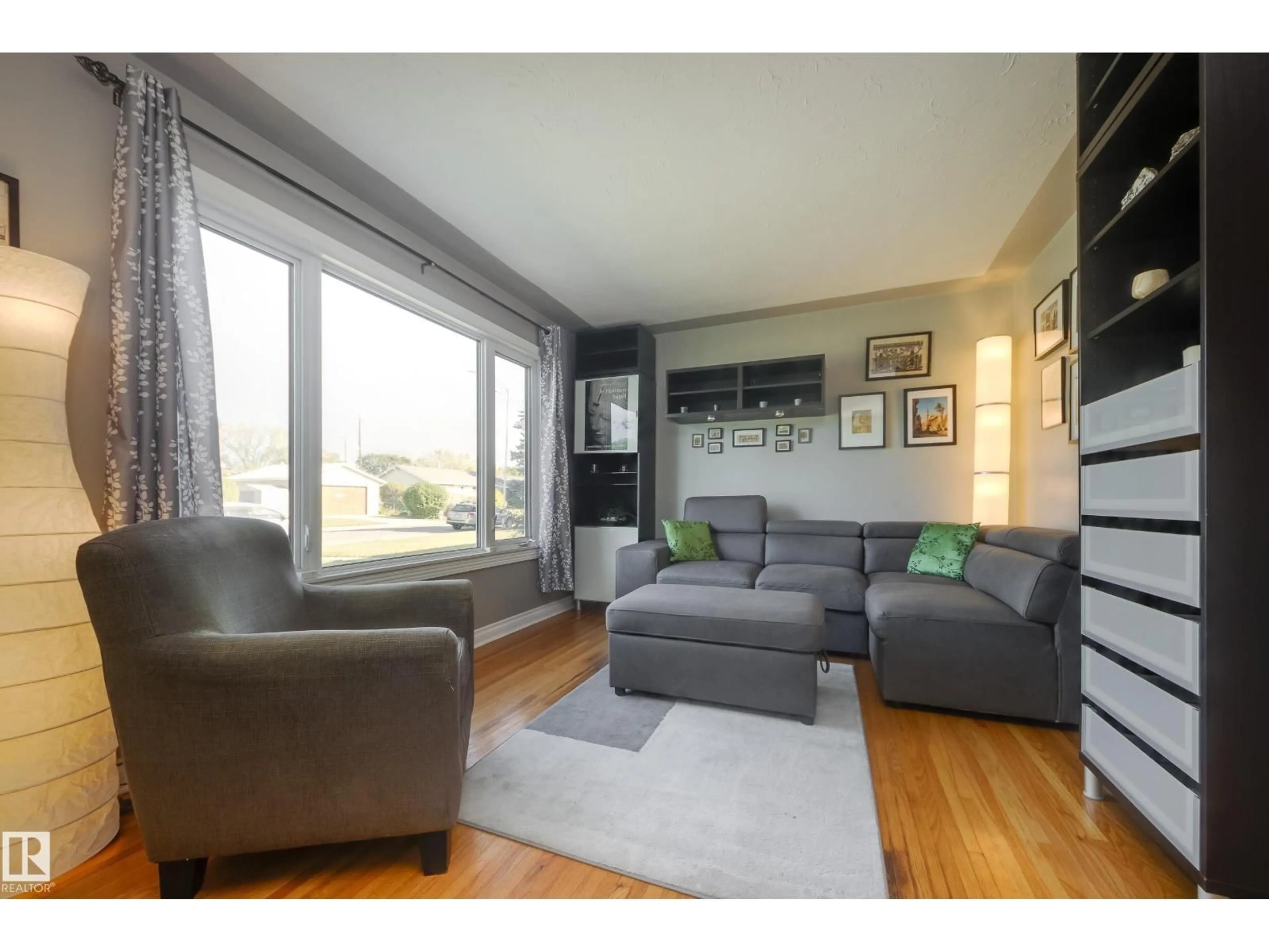 Living room with furniture, wood/laminate floor for 13039 128A AV, Edmonton Alberta T5L3H8