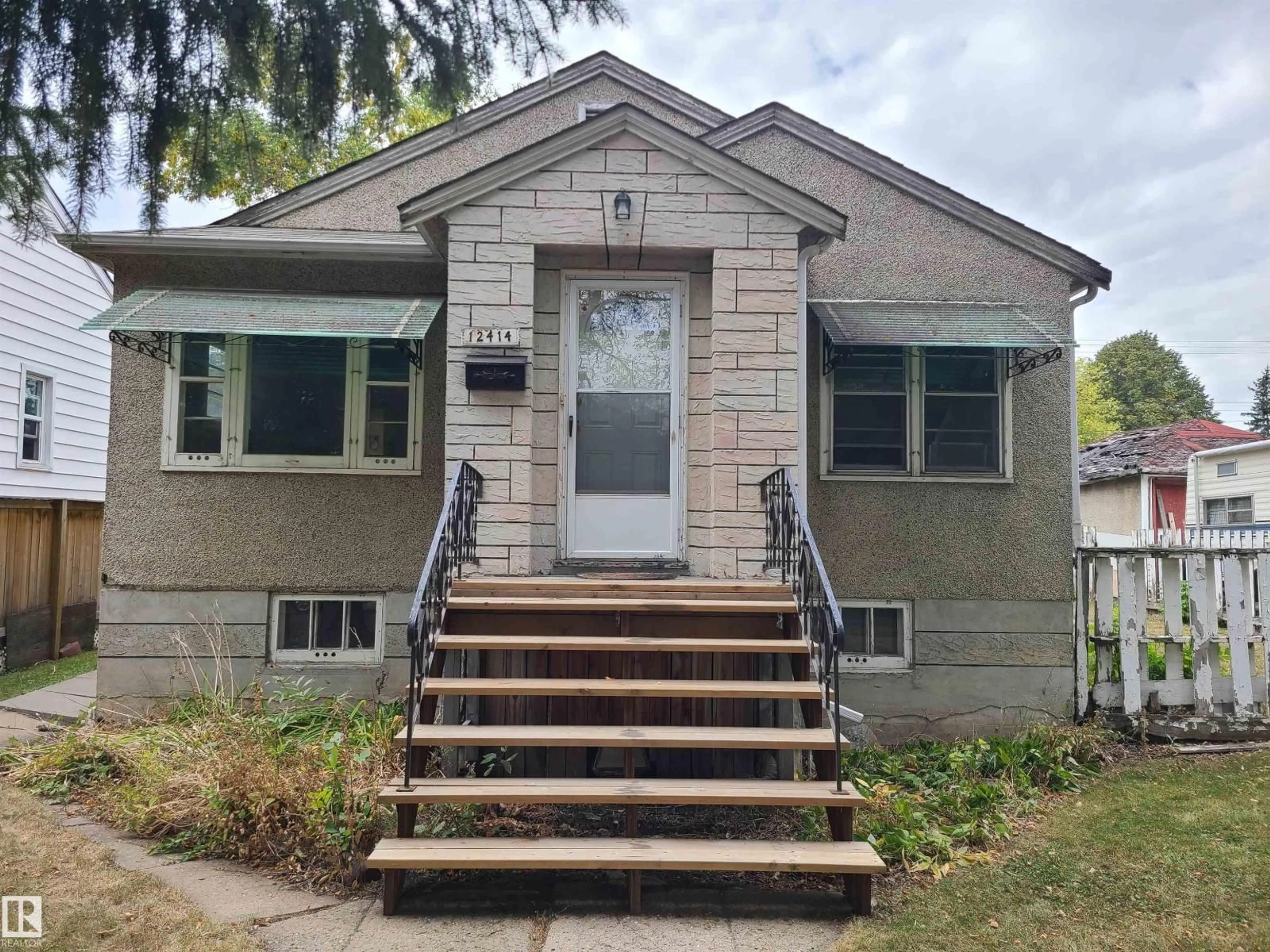 Home with vinyl exterior material, street for 12414 90 ST, Edmonton Alberta T5B3Z8