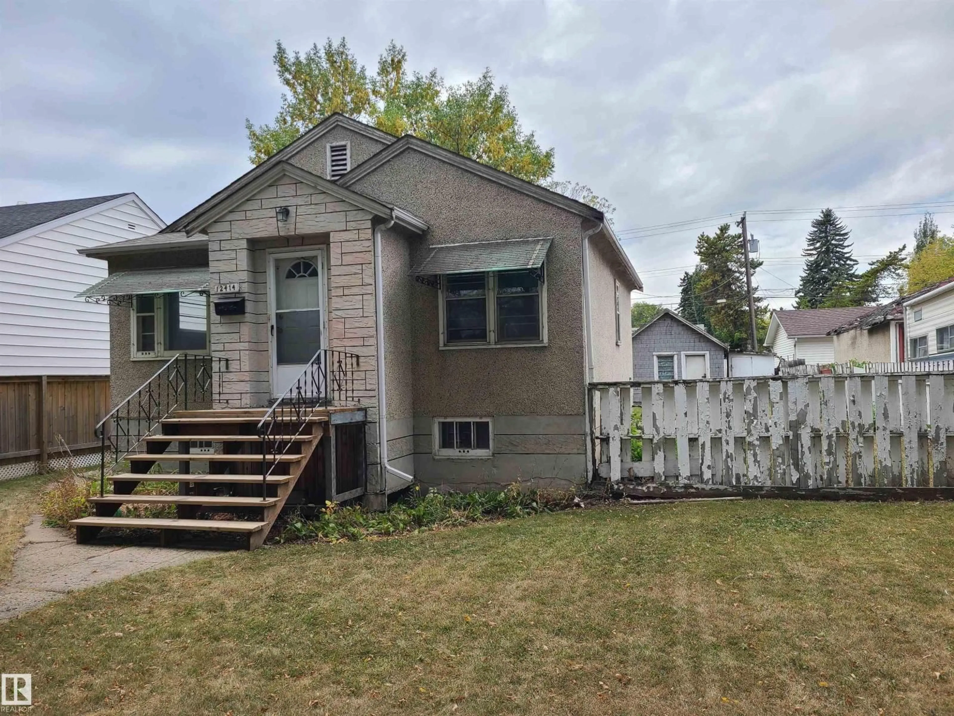Home with vinyl exterior material, street for 12414 90 ST, Edmonton Alberta T5B3Z8