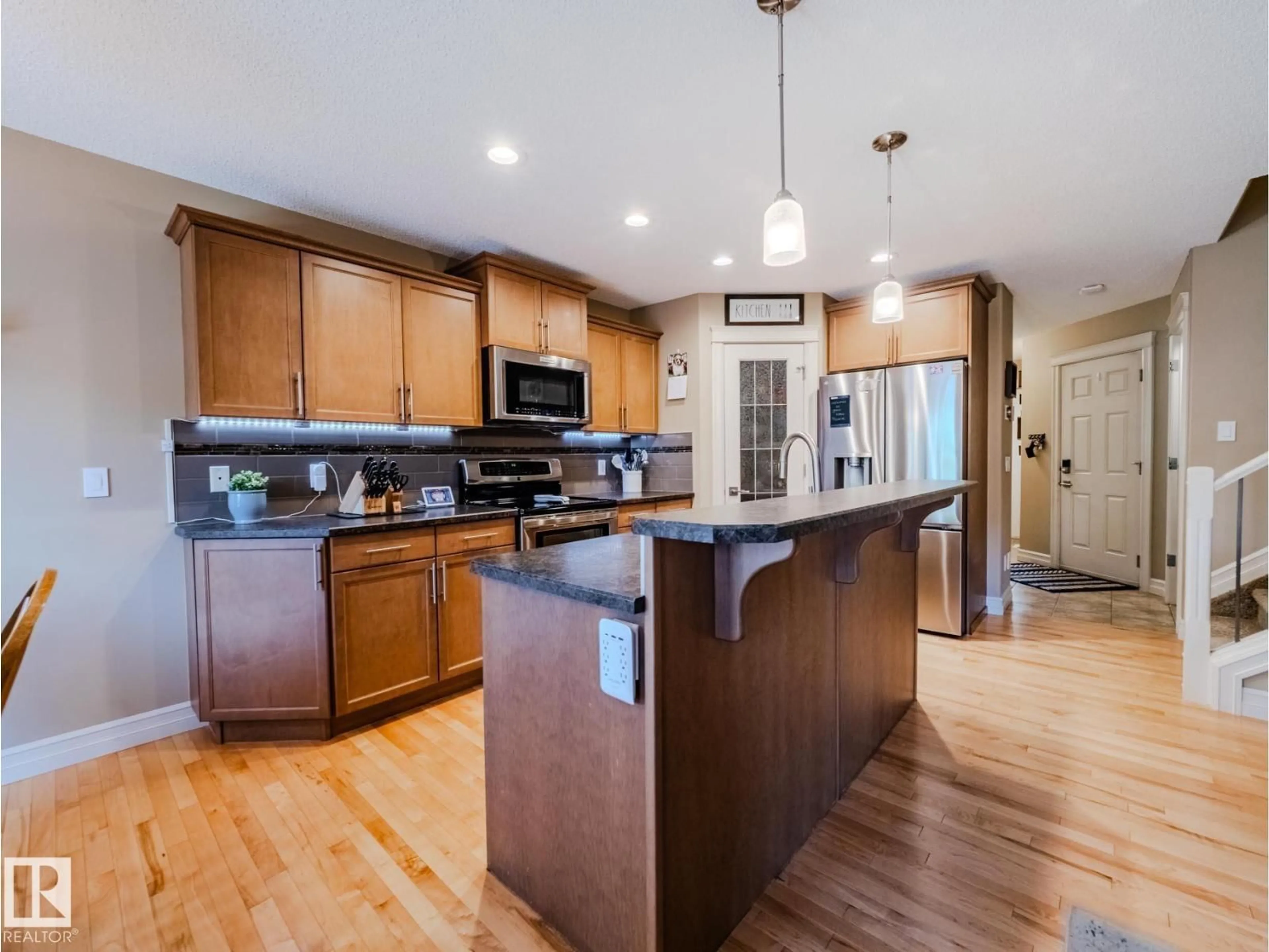 Open concept kitchen, wood/laminate floor for 2317 CASSELMAN CR, Edmonton Alberta T6W0W1