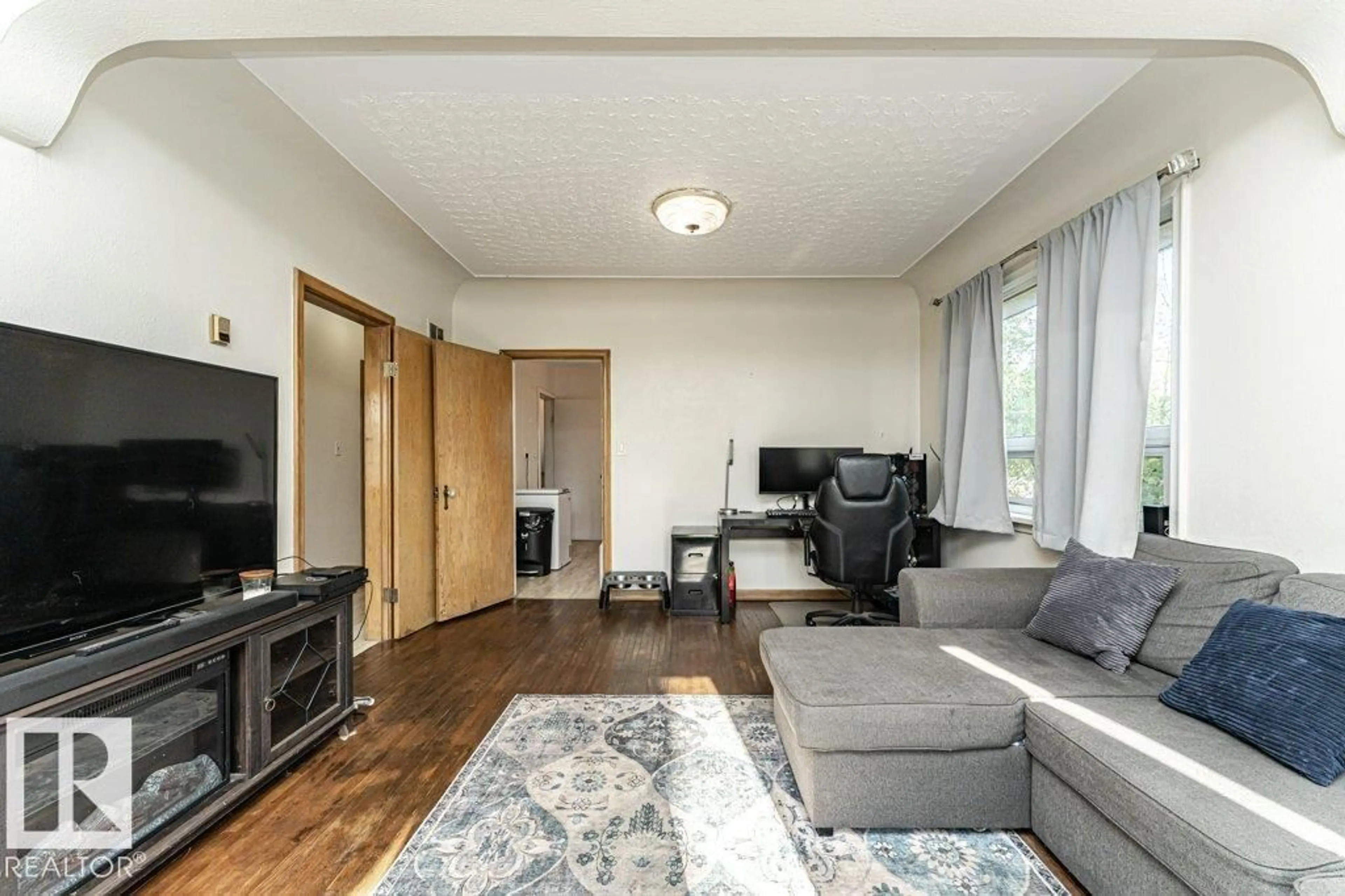 Living room with furniture, wood/laminate floor for 10012 96A AV, Fort Saskatchewan Alberta T8L1P8