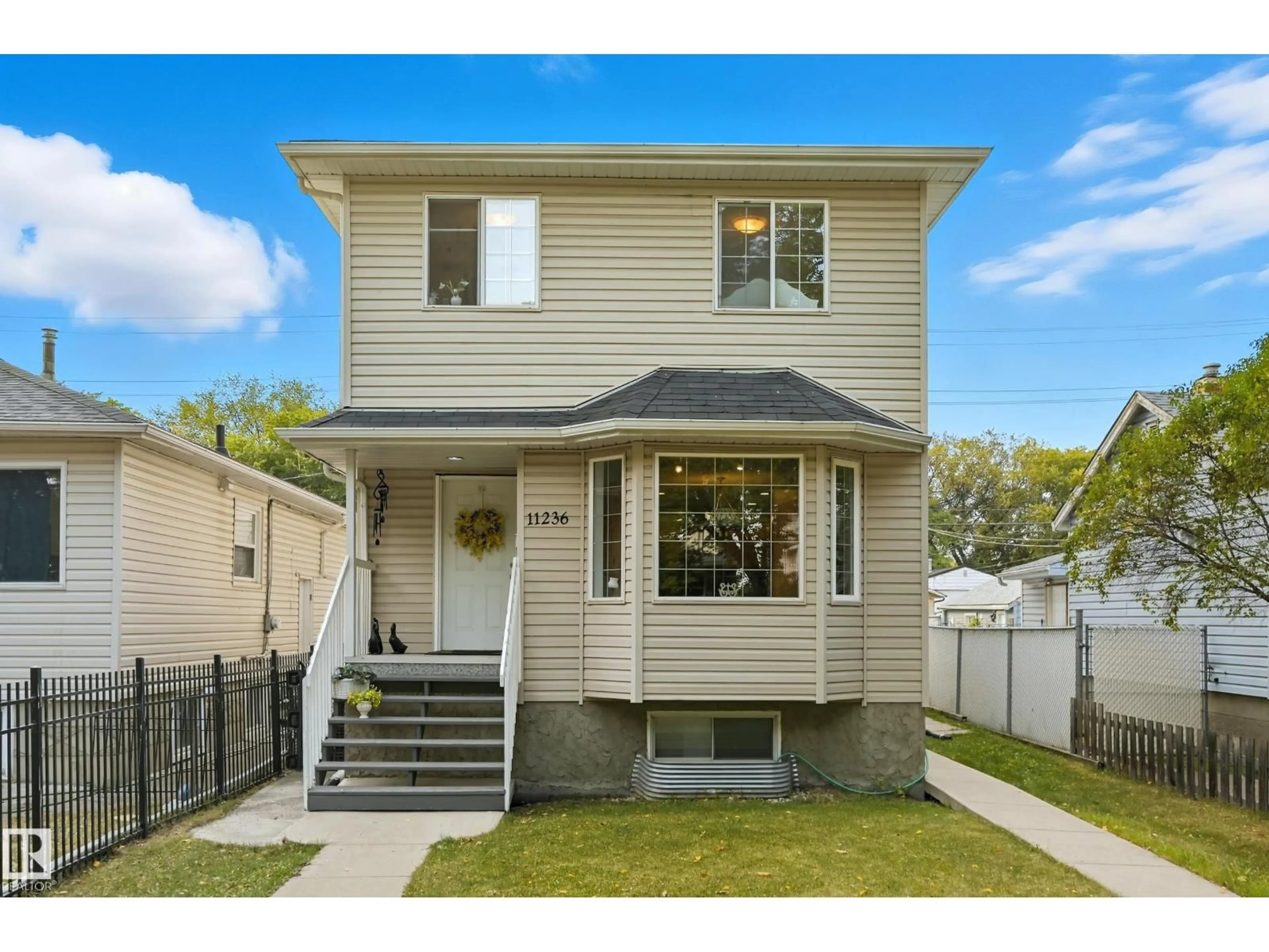 Home with vinyl exterior material, street for 11236 84 ST, Edmonton Alberta T5B3A9