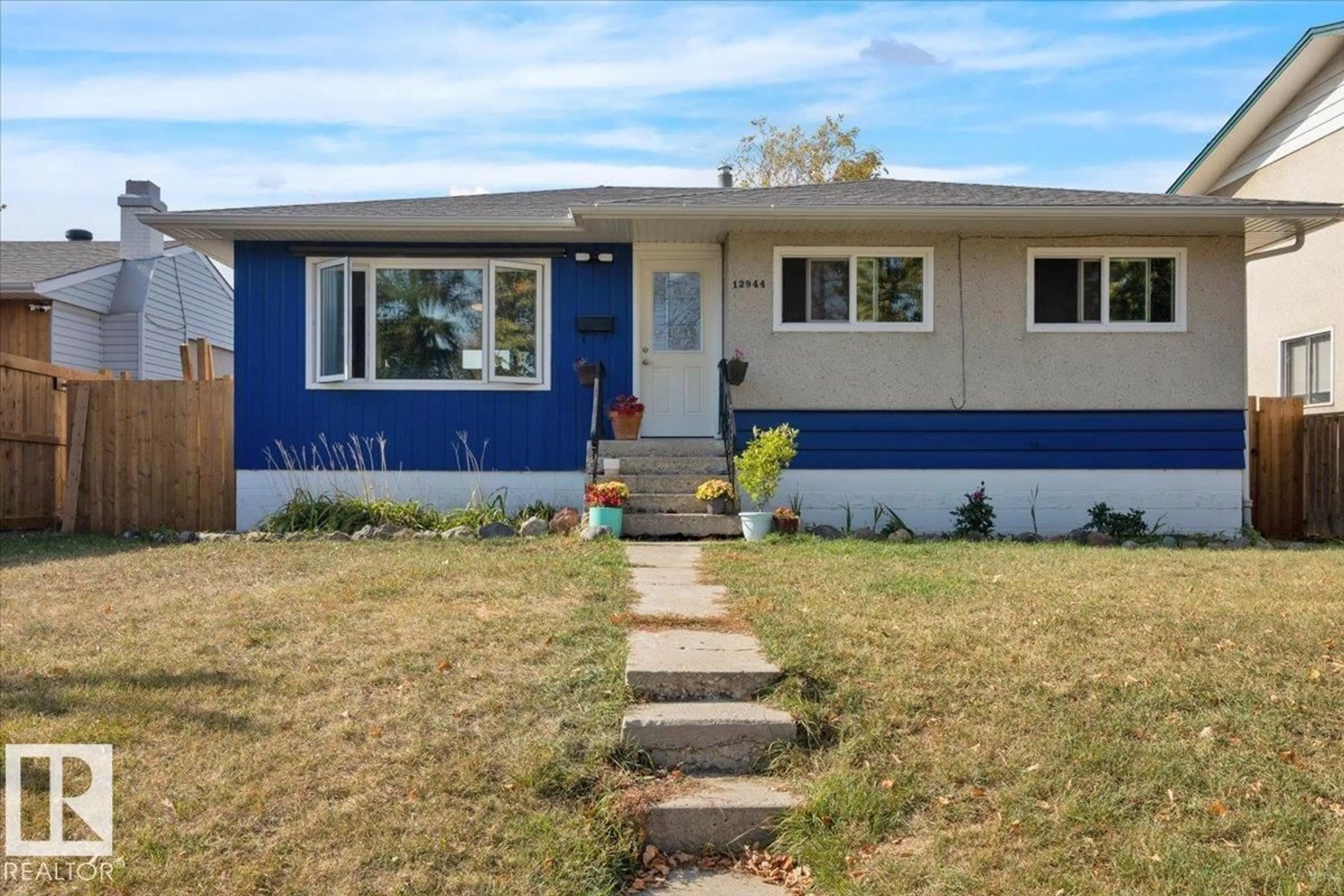 Home with vinyl exterior material, street for 12944 128 ST, Edmonton Alberta T5L1E5