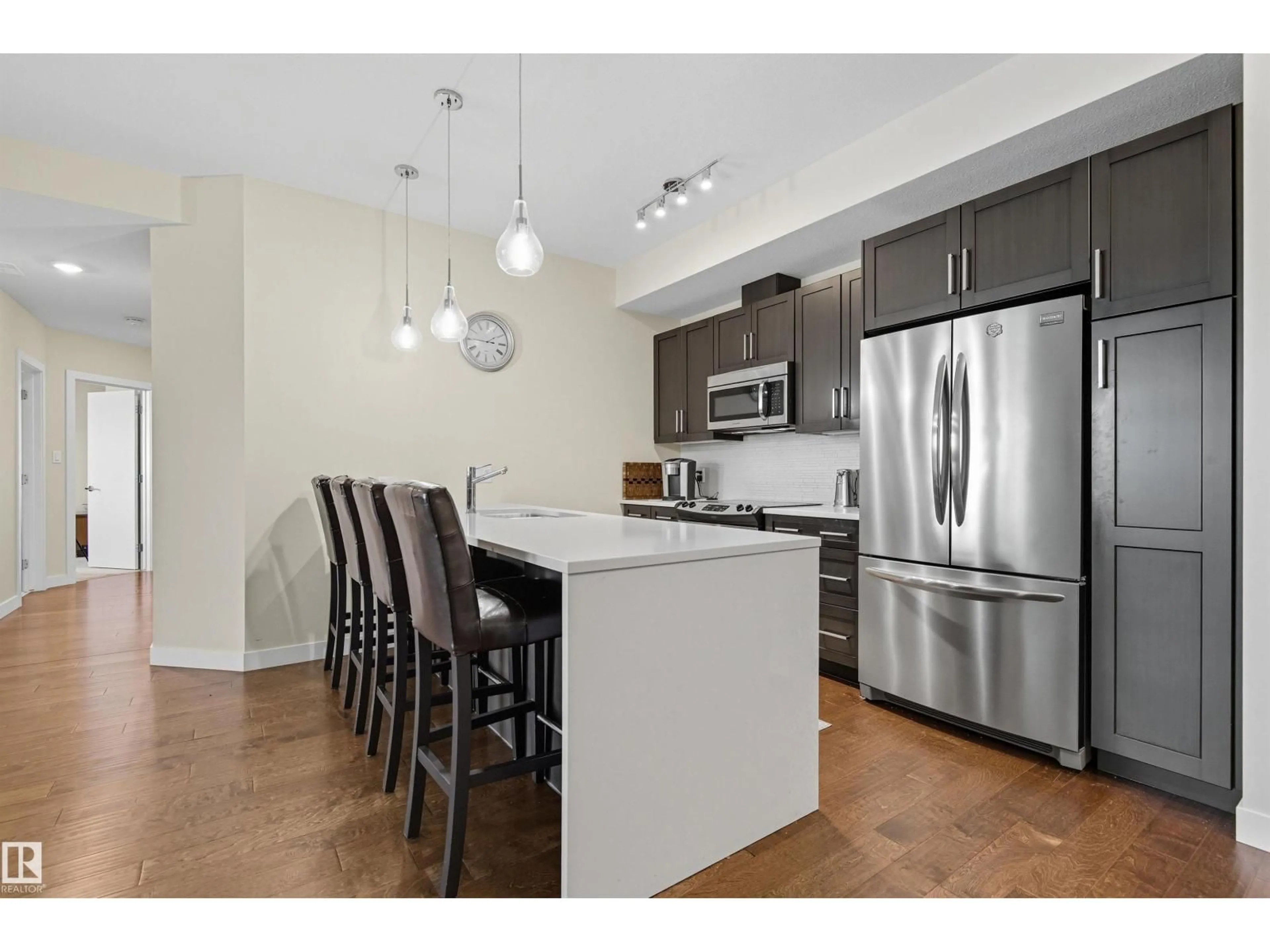 Open concept kitchen, wood/laminate floor for #414 - 625 LEGER WY, Edmonton Alberta T6R0W4
