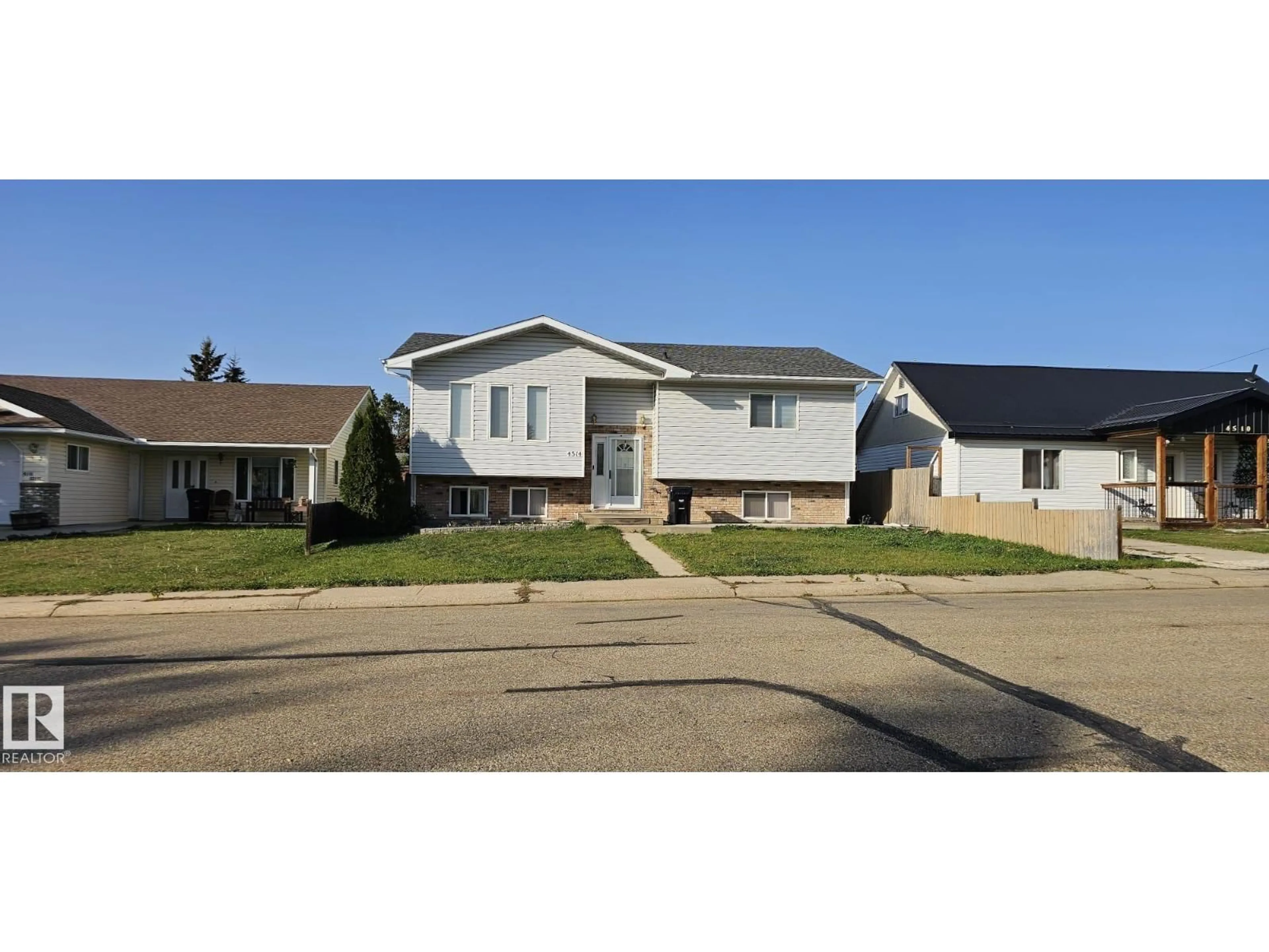 Home with vinyl exterior material, street for 4514 56 AV, Barrhead Alberta T7N1K6