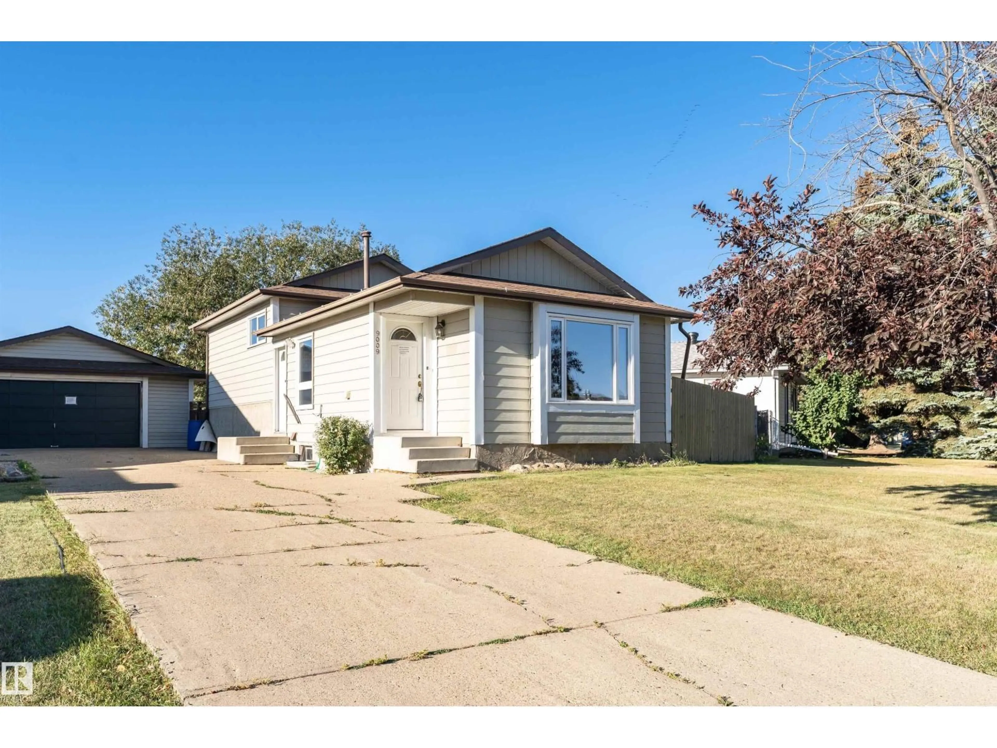 Home with vinyl exterior material, street for 9009 102 AV, Morinville Alberta T8R1B5
