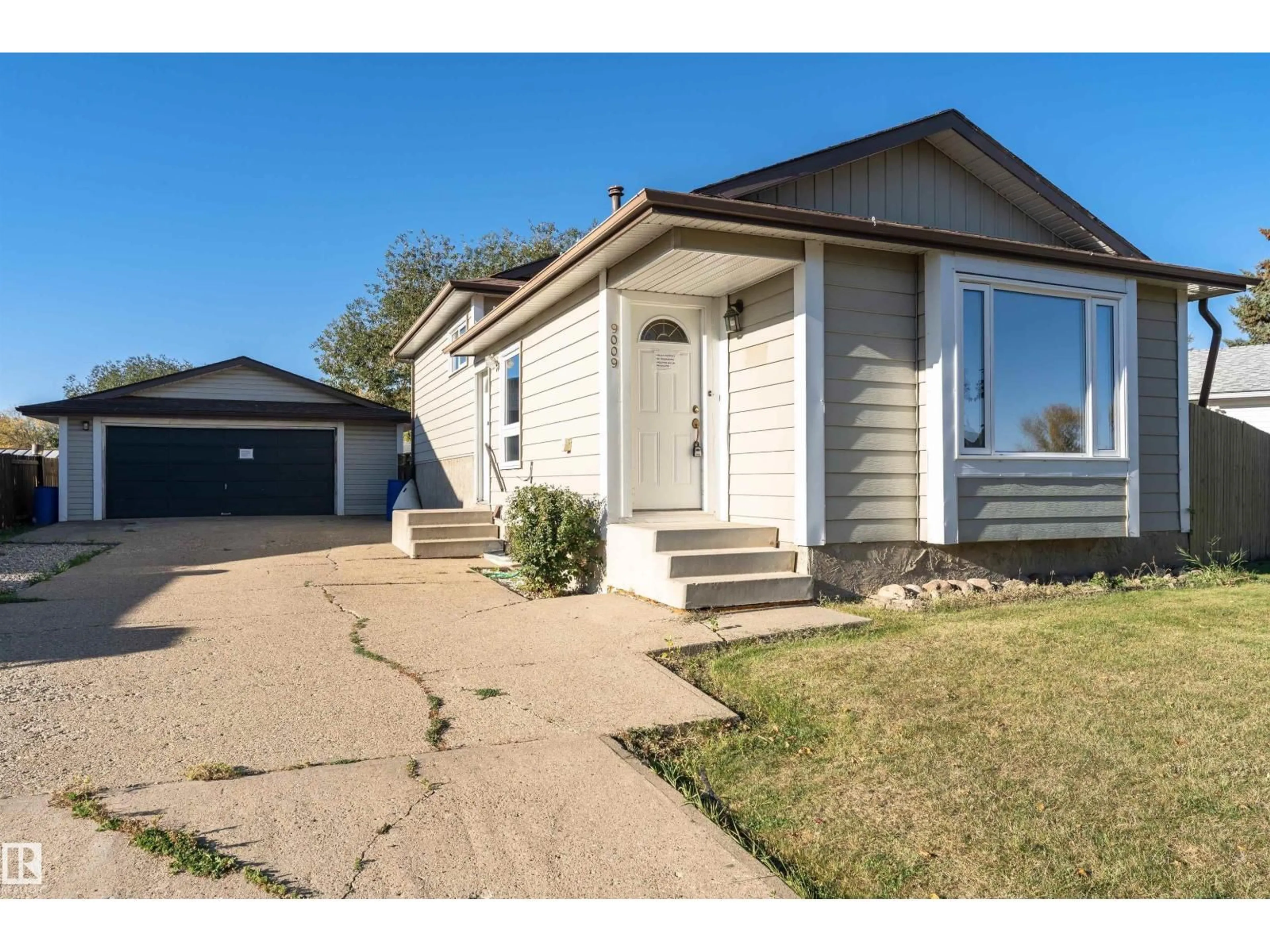 Home with vinyl exterior material, street for 9009 102 AV, Morinville Alberta T8R1B5
