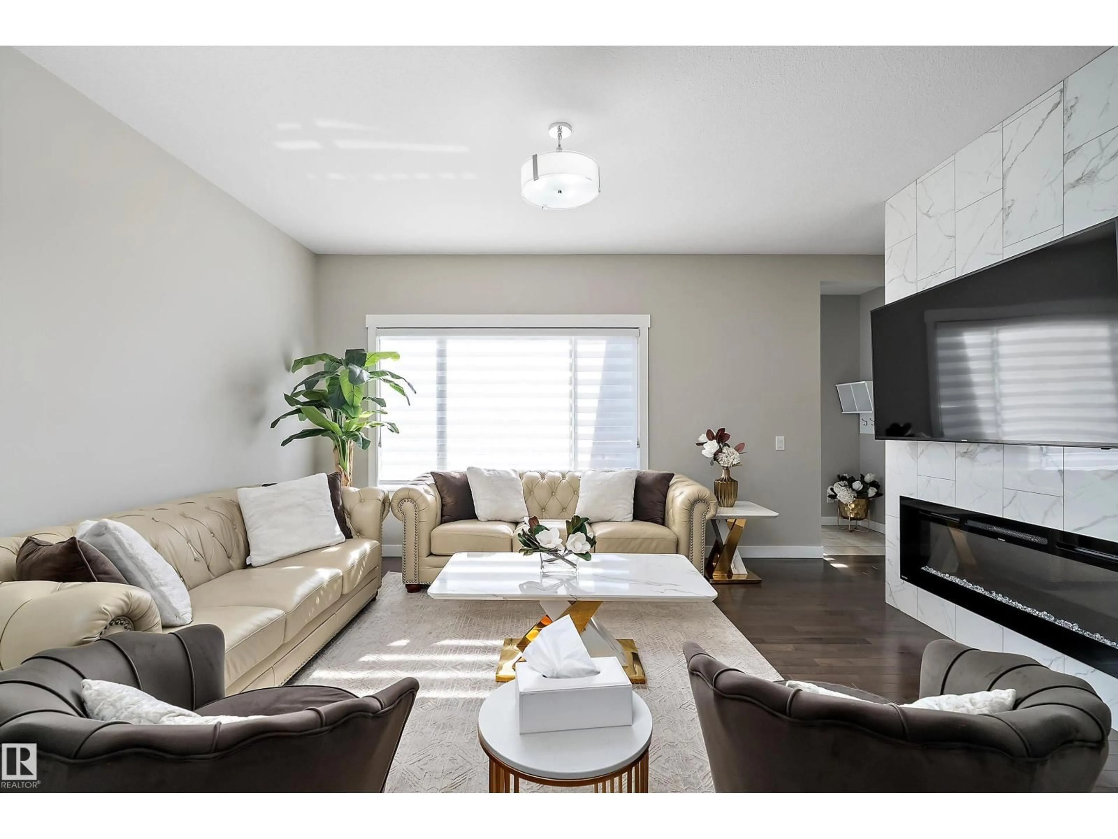 Living room with furniture, wood/laminate floor for 7043 174 AV, Edmonton Alberta T5Z0L3