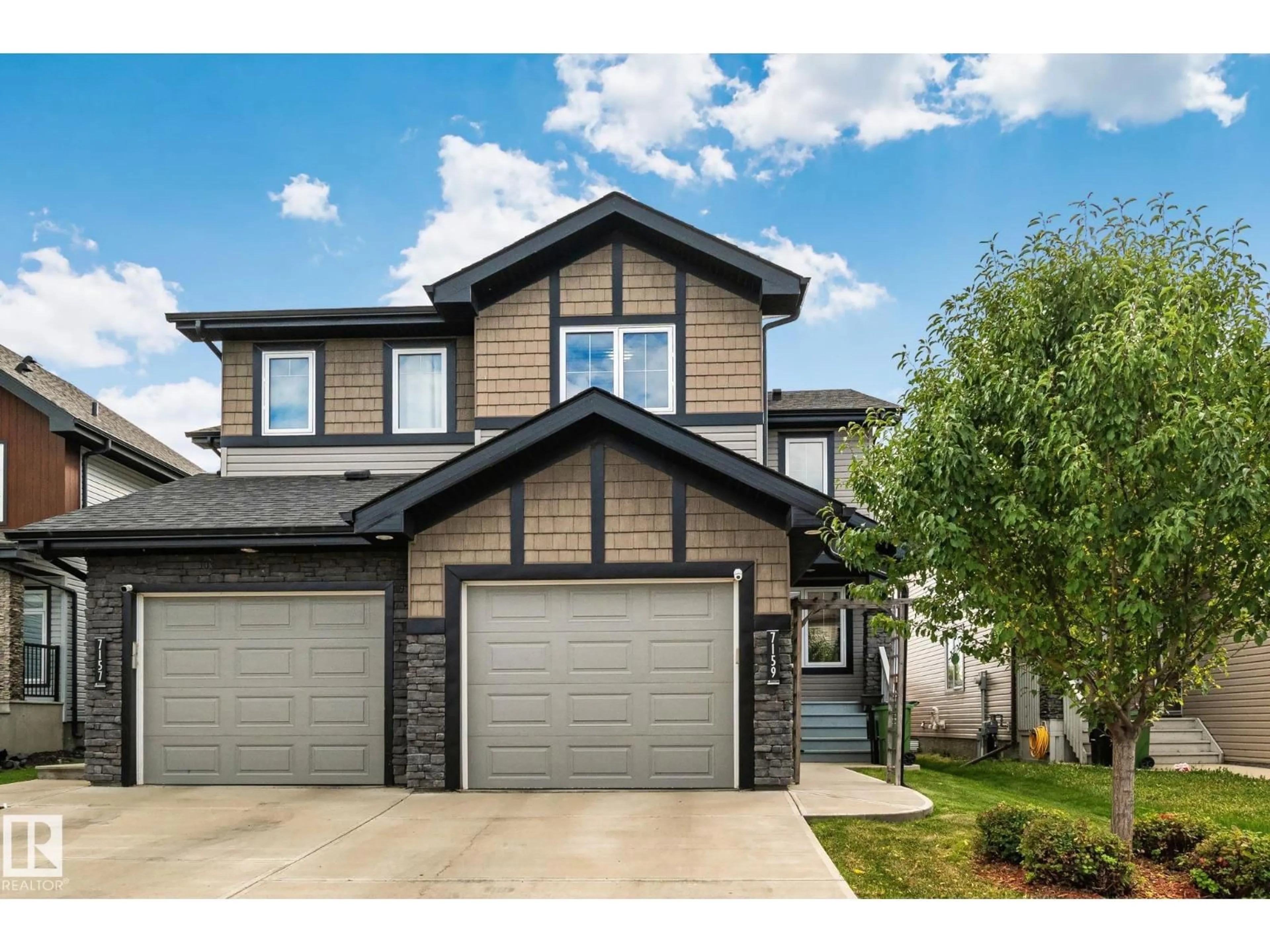 Home with vinyl exterior material, street for 7159 CARDINAL WY, Edmonton Alberta T5W2Y3