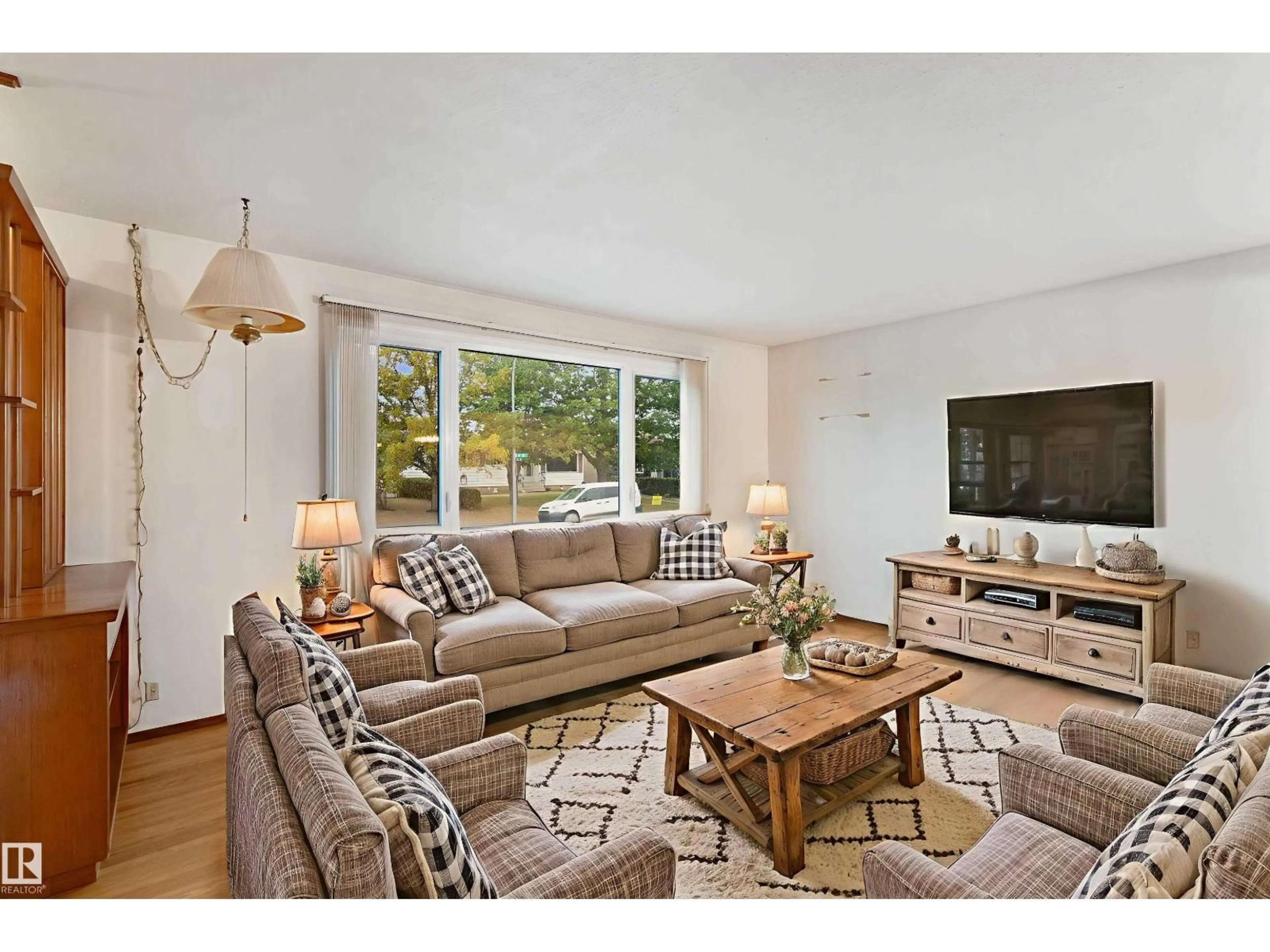 Living room with furniture, wood/laminate floor for 13015 81 ST, Edmonton Alberta T5C1N3