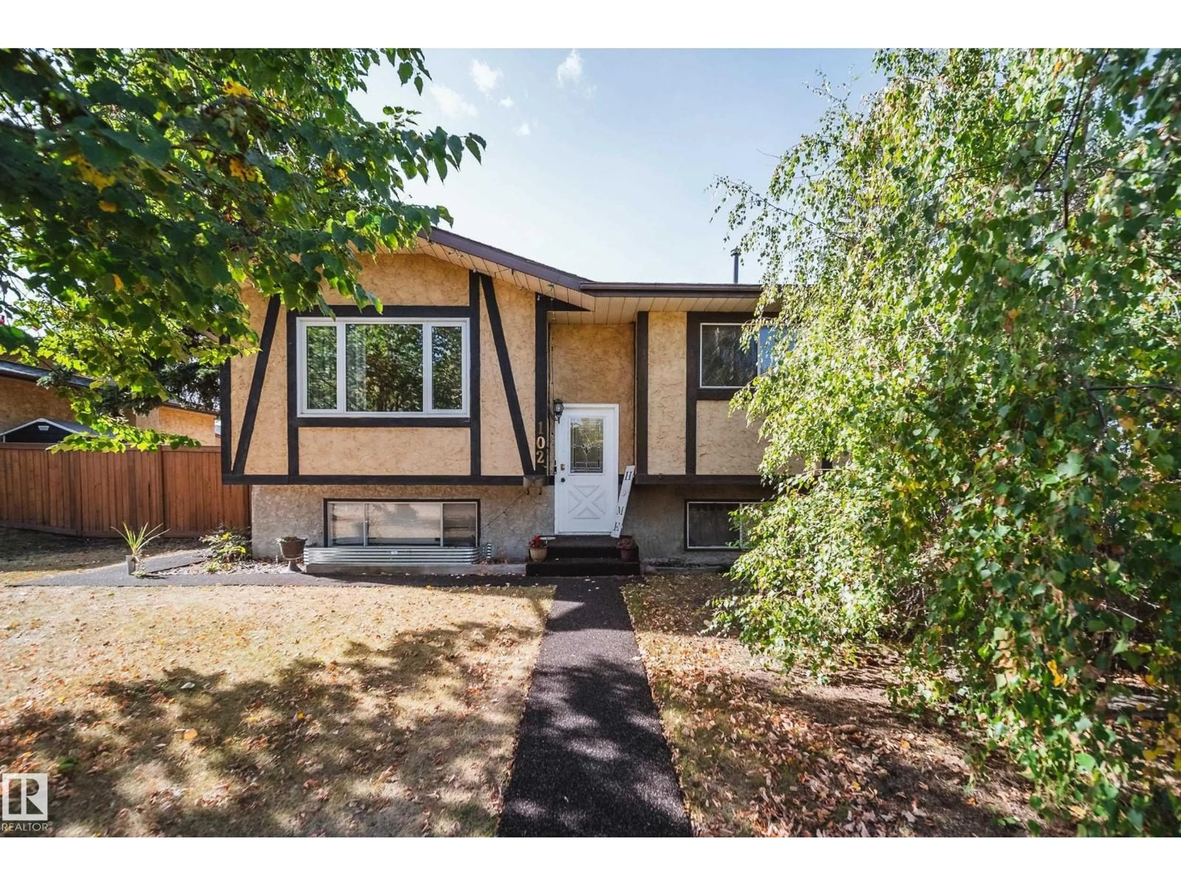 Home with vinyl exterior material, street for 102 WOODVALE RD, Edmonton Alberta T6L1P7