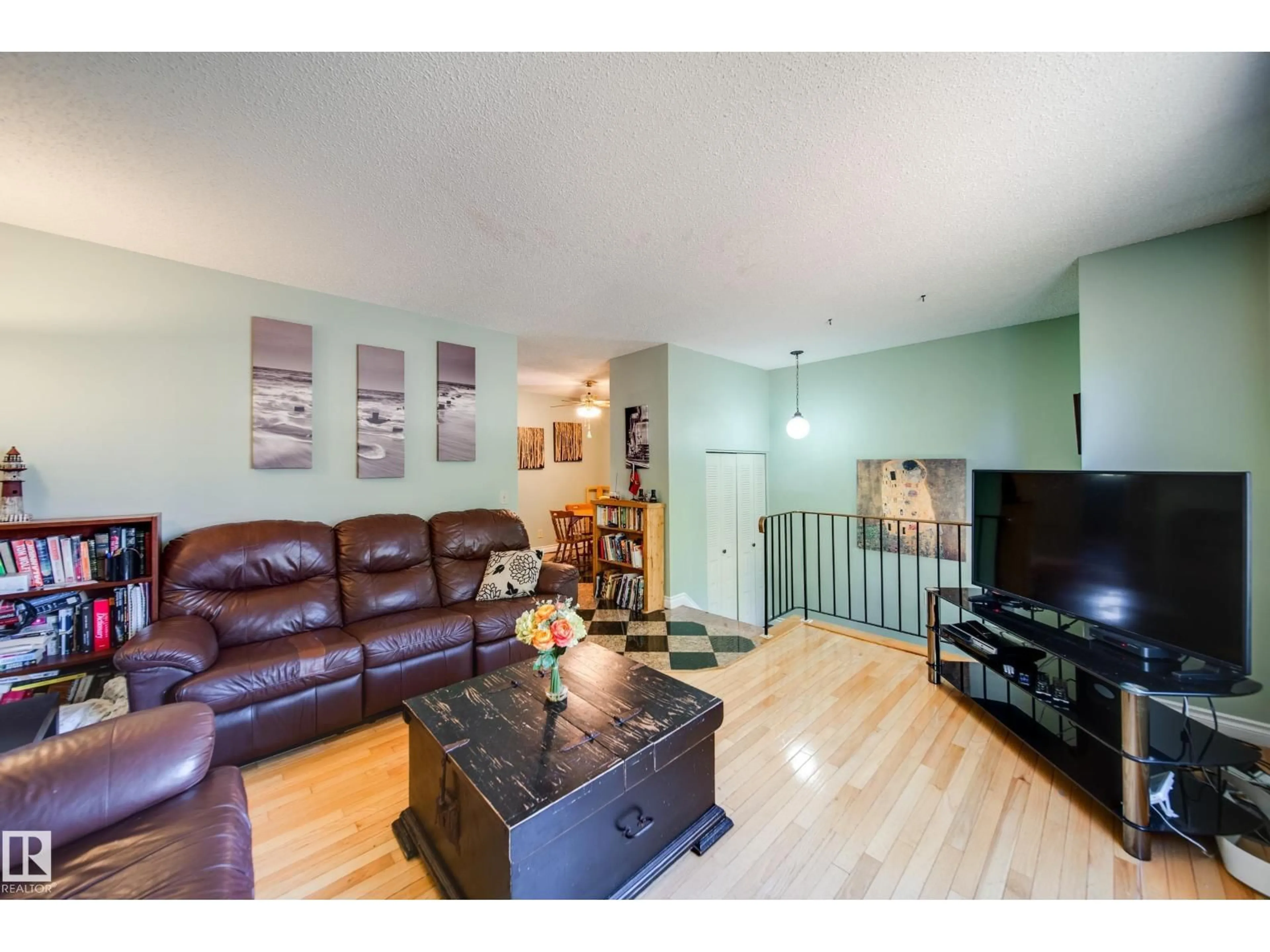 Living room with furniture, wood/laminate floor for 102 WOODVALE RD, Edmonton Alberta T6L1P7