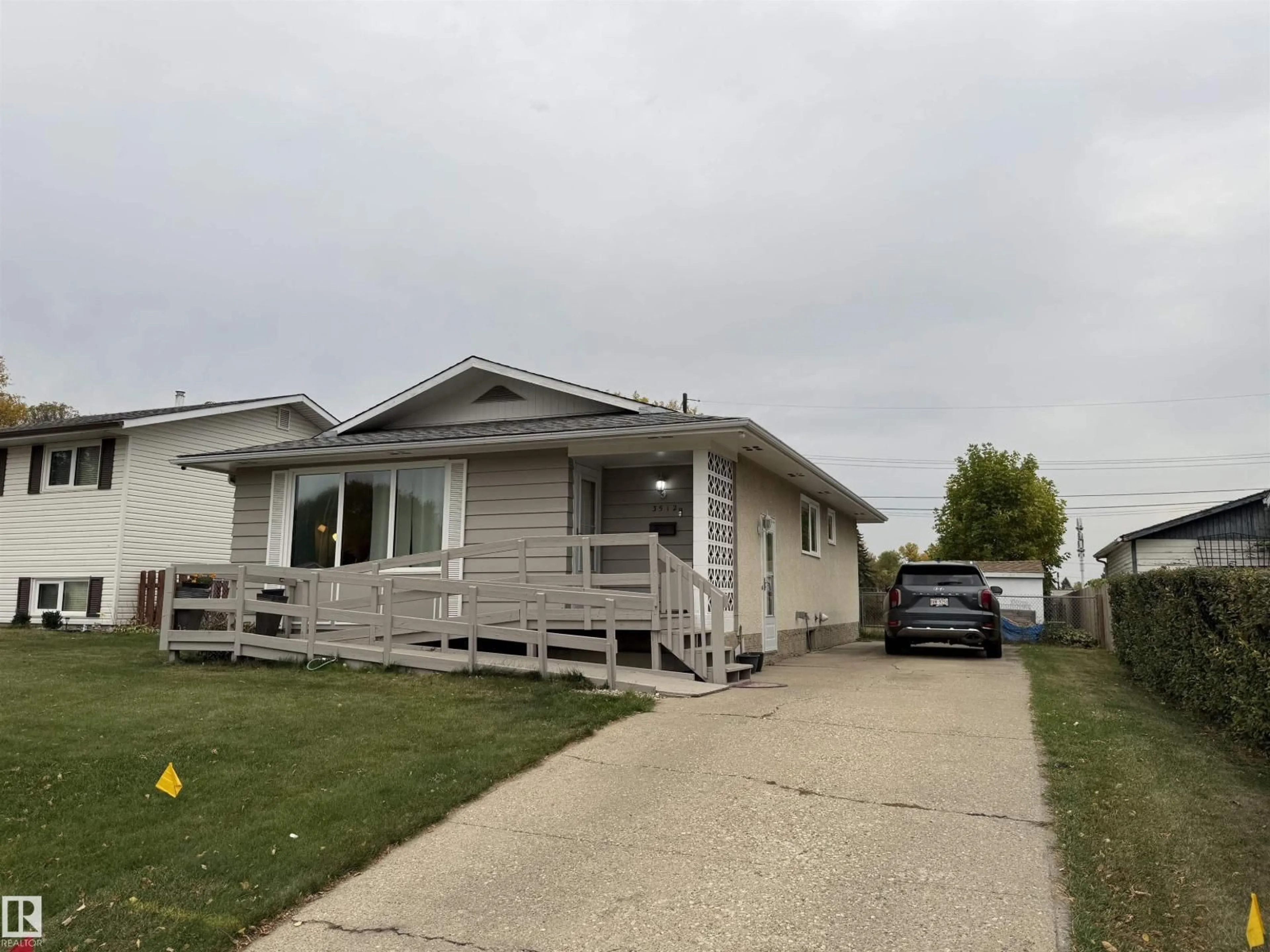 Home with vinyl exterior material, street for 3512 114 AV, Edmonton Alberta T5W0S3