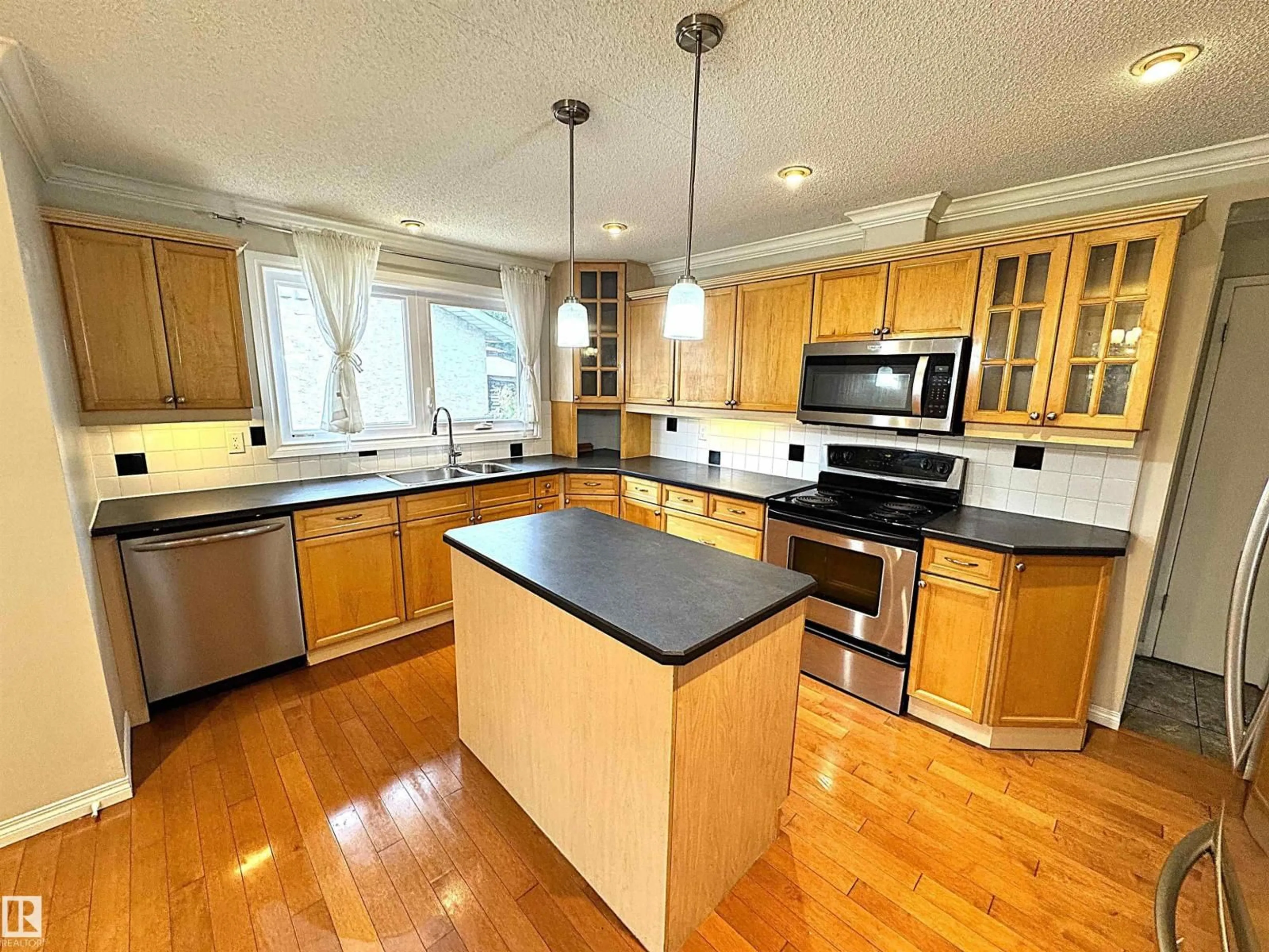 Open concept kitchen, wood/laminate floor for NW - 3607 104 ST, Edmonton Alberta T6J2J8